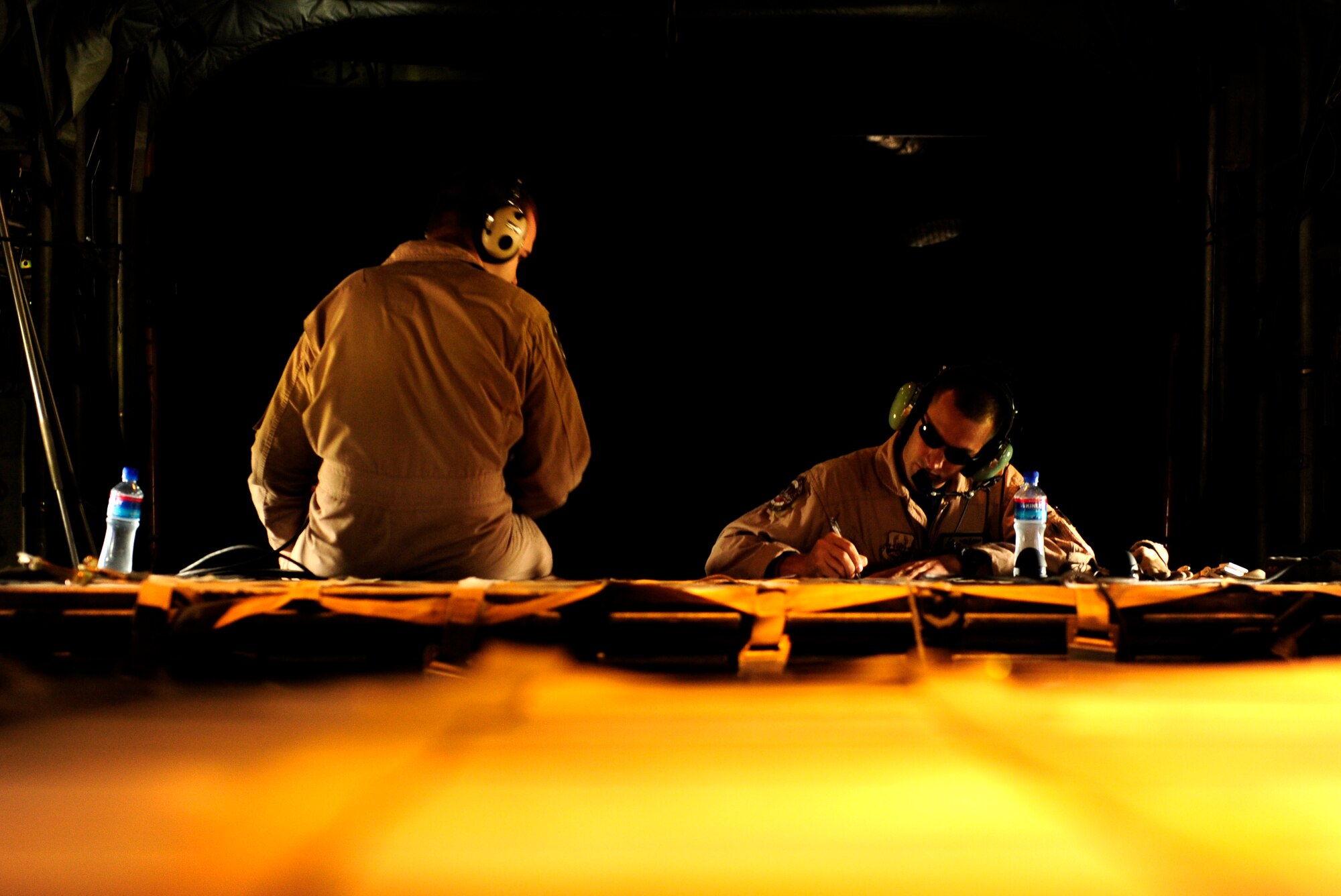 U.S. Air Force C-130H Hercules loadmasters Senior Airman Shon Manning(left) and Master Sgt. John Metcalf assigned to the 746th Expeditionary Airlift Squadron fill in all necessary paperwork before off load of cargo in support of humanitarian relief efforts in Pakistan from Bagram Airfield, Afghanistan, Aug. 20, 2010. (U.S. Air Force photo by Staff Sgt. Andy M. Kin/Released)