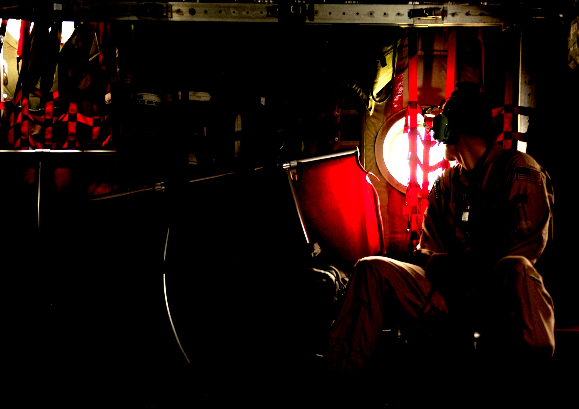 U.S. Air Force Master Sgt. John Metcalf, a C-130H Hercules loadmaster assigned to the 746th Expeditionary Airlift Squadron, looks out at a flooded Pakistan during a flying mission in support of humanitarian relief efforts Aug. 20, 2010. The 746 EAS is staged out of Bagram Airfield, Afghanistan. (U.S. Air Force photo by Staff Sgt. Andy M. Kin/Released)