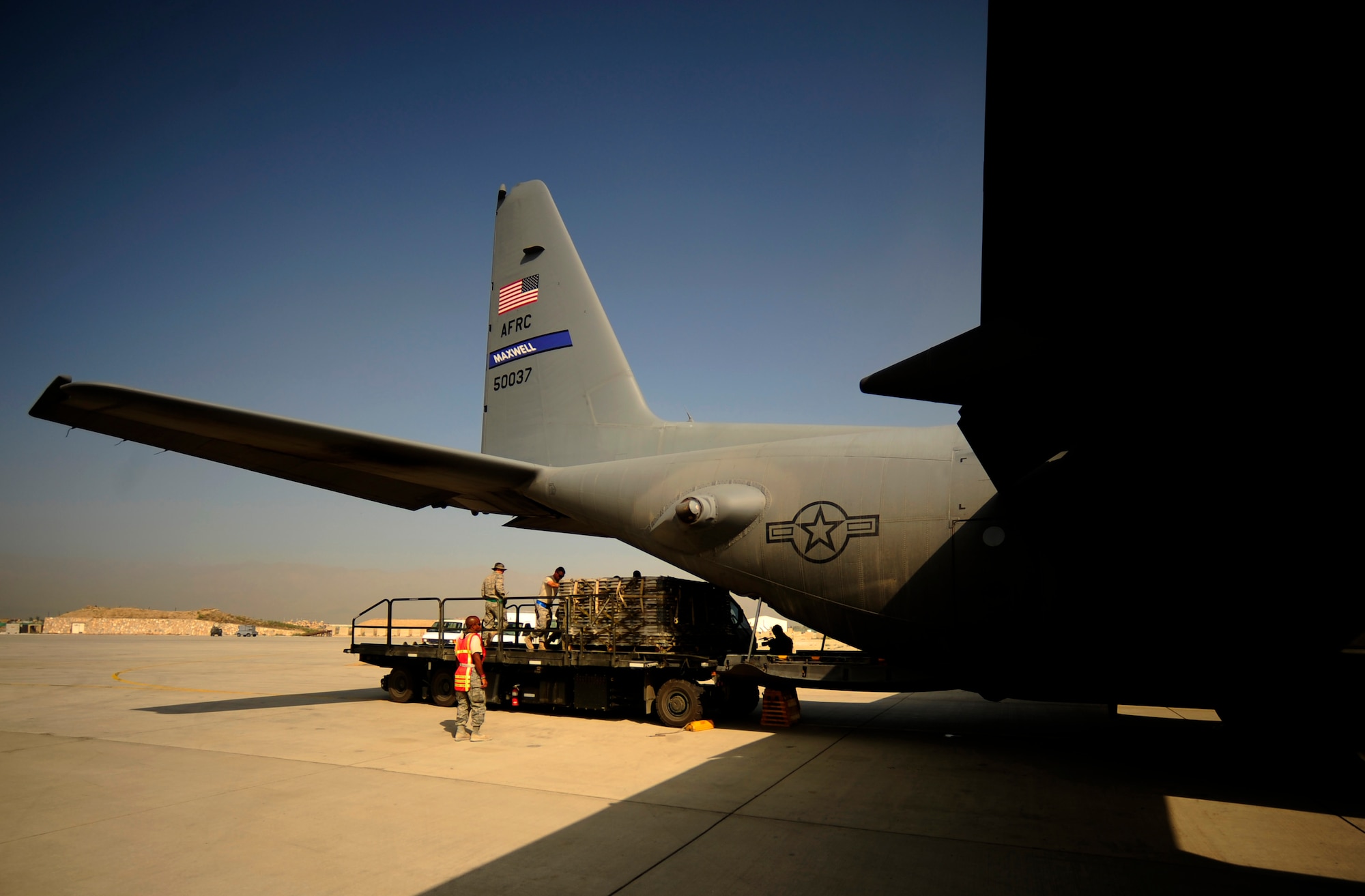 U.S. Air Force Airmen from the 746th Expeditionary Airlift Squadron load aid and supplies onto a C-130H Hercules aircraft, in support of humanitarian relief efforts in Pakistan at Bagram Airfield, Afghanistan, Aug. 20, 2010. (U.S. Air Force photo by Staff Sgt. Andy M. Kin/Released)