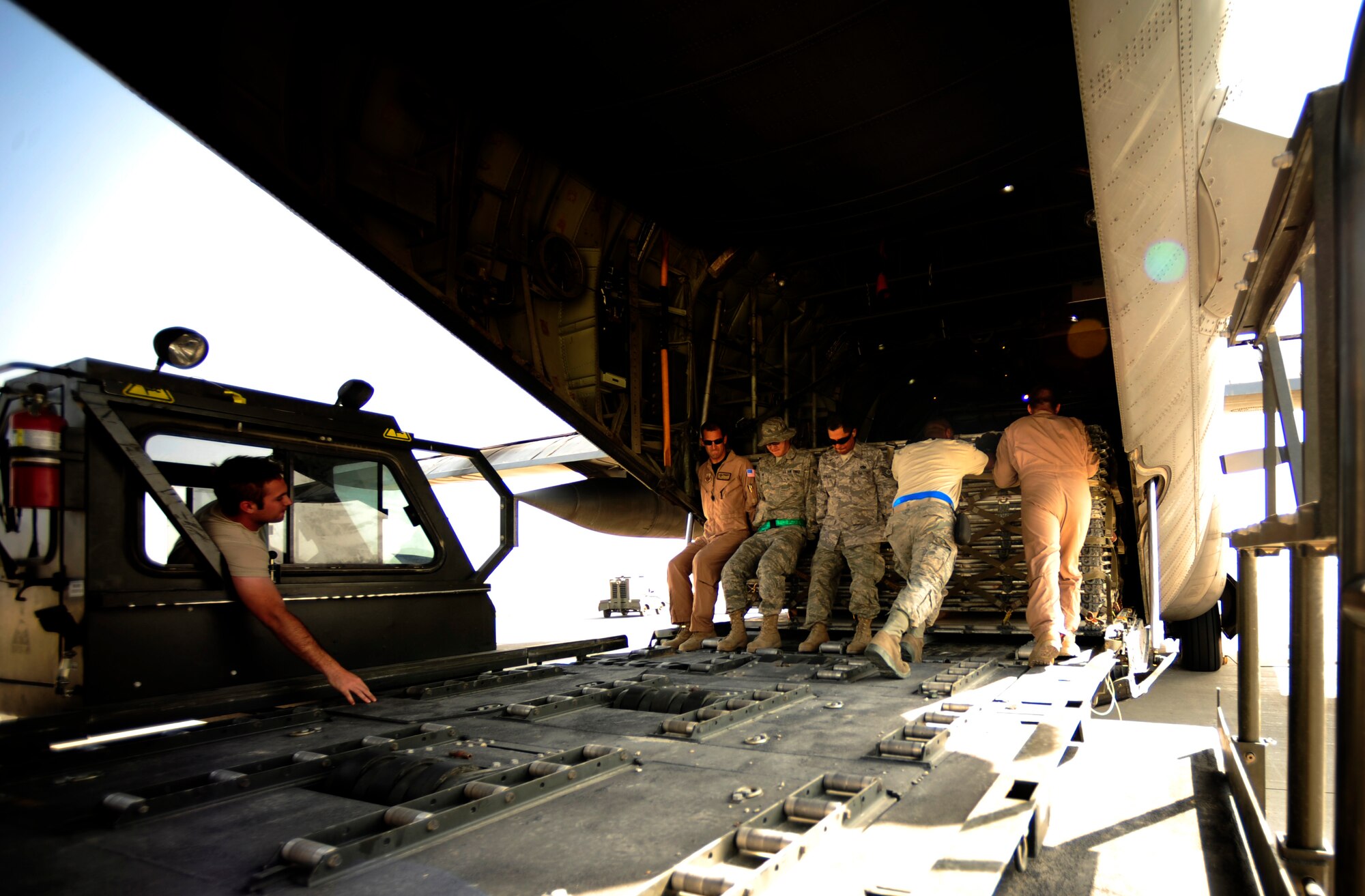 U.S. Air Force Airmen aircraft from the 746th Expeditionary Airlift Squadron load aid and supplies onto a C-130H Hercules, in support of humanitarian relief efforts in Pakistan at Bagram Airfield, Afghanistan, Aug. 20, 2010. (U.S. Air Force photo by Staff Sgt. Andy M. Kin/Released)
