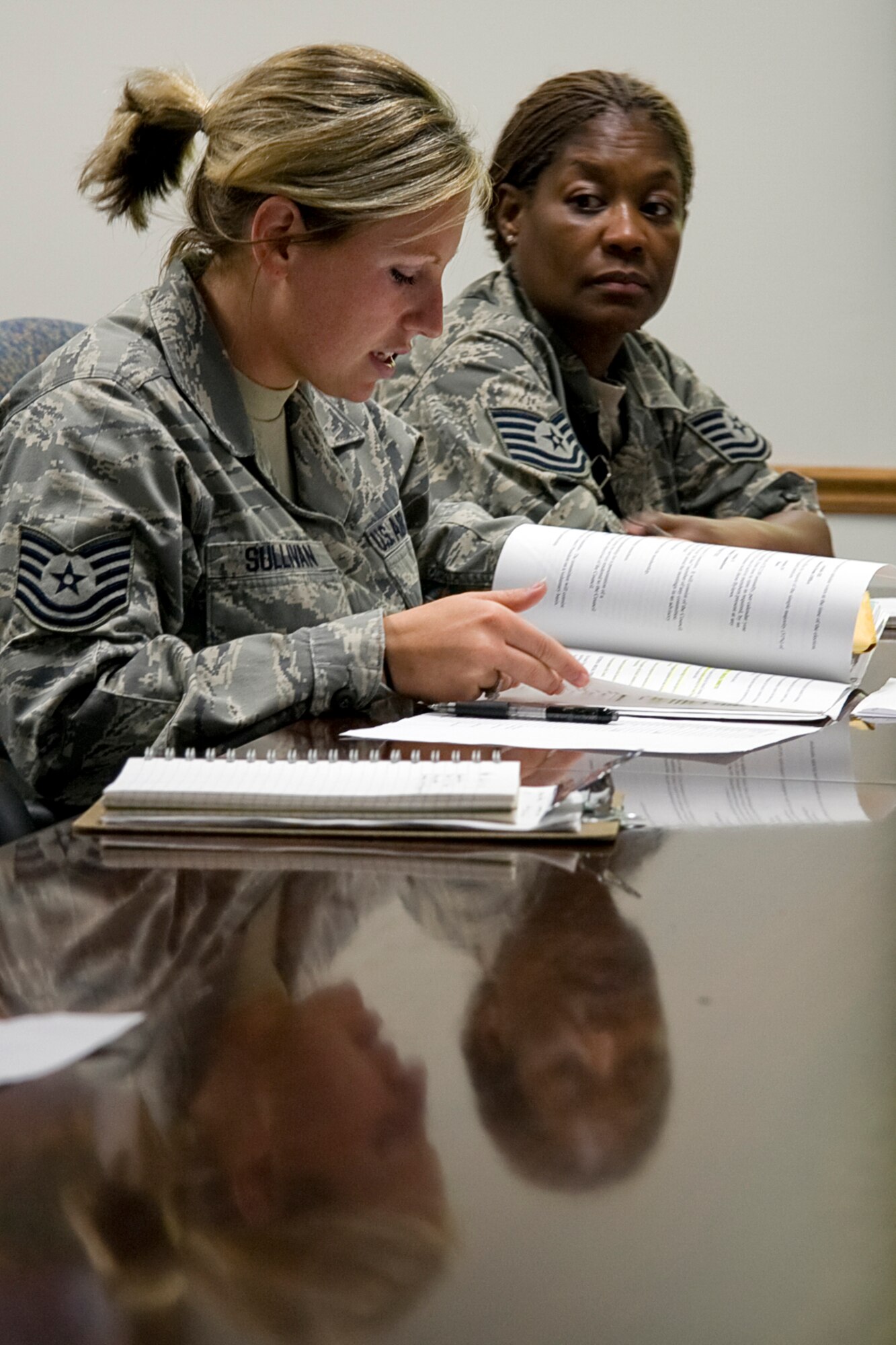GRISSOM AIR RESERVE BASE, Ind. -- Tech. Sgt. Jonna Sullivan, Grissom Rising Six treasurer, briefs other Rising Six members on financial matters as Tech. Sgt. Joyce Royston listens intently during a meeting Aug. 8. The Rising Six is an organization for Grissom Airmen from the ranks of airman basic through technical sergeant. The mission of the organization is to establish and maintain a spirit of comradeship and esprit de corps that will enhance the prestige of all Airmen, encourage an attitude of unified purpose and set an example for all enlisted personnel according to the standards, traditions and customs of the U.S. Air Force. Sergeant Royston is the group's vice president. (U.S. Air Force photo/Tech. Sgt. Mark R. W. Orders-Woempner)