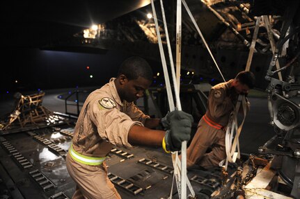 Airman First Class Jamil Harrison front, a  C-17A Globemaster III loadmaster and Capt. Brandon Wood a C-17A pilot both  assigned to the14th Airlift Squadron, load the main gear box of a U.S. Marine Corps MH-53E Super Stallion, Aug. 20, 2010 at Marine Corps Air Station Cherry Point, NC. The mission is in support of the Pakistan flood relief efforts. (U.S. Air Force photo/Staff Sgt. Manuel J. Martinez)