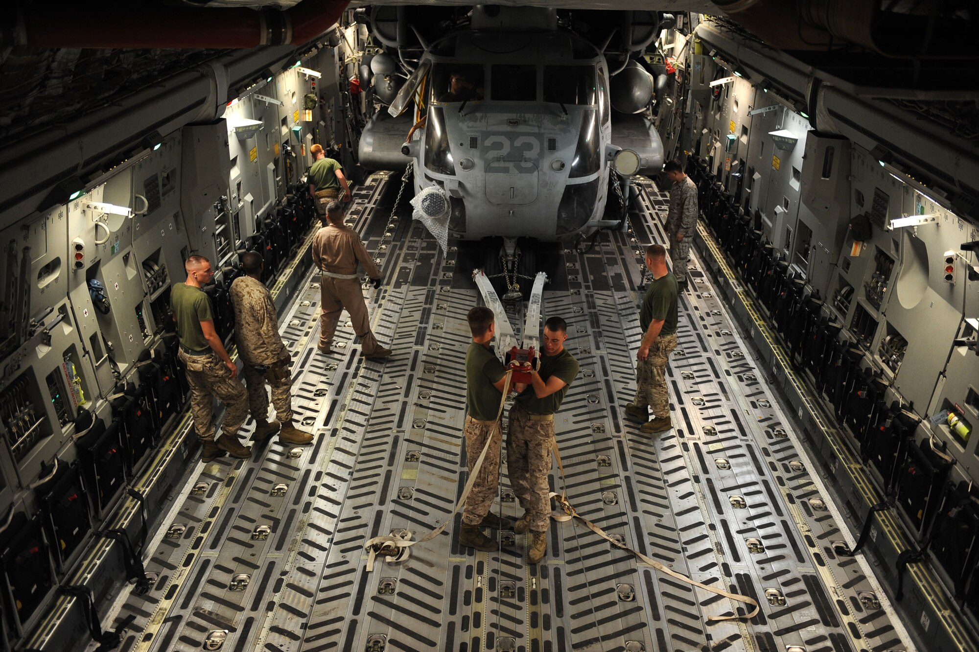 Master Sgt. Bill Lasage a C-17A Globemaster III loadmaster assigned to the14th Airlift Squadron and U.S. Marines assigned to the 266th Medium Tilt Rotor Squadron, position a U.S. Marine Corps MH-53E Super Stallion in the cargo area of a C-17A aircraft , Aug. 21, 2010 at Marine Corps Air Station Cherry Point, NC. The mission is in support of the Pakistan flood relief efforts. (U.S. Air Force photo/Staff Sgt. Manuel J. Martinez)