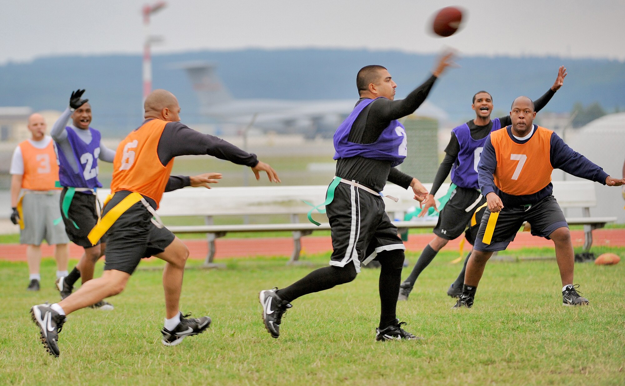 SPANGDAHLEM AIR BASE, Germany – Alex Machado, quarterback for the 52nd Force Support Squadron/Maintenance Operation Squadron flag football team, evades from the726th Air Mobility defenders Squadron completing a pass to an open receiver during a flag football game Aug. 17. The 52nd FSS/MOS defeated the 726th Air Mobility Squadron in overtime 14-13. (U.S. Air Force photo/Senior Airman Nick Wilson)