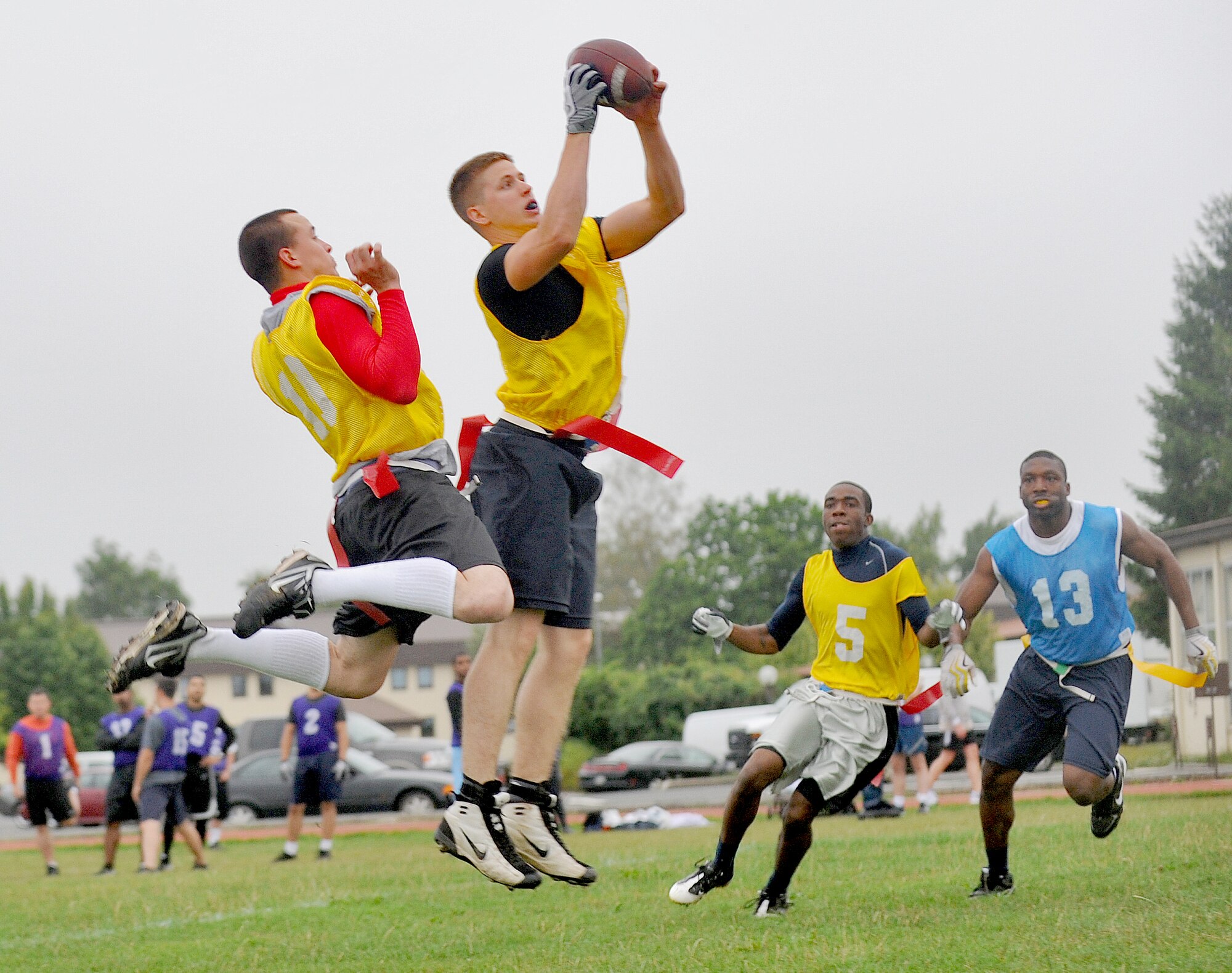 SPANGDAHLEM AIR BASE, Germany – Defenders from the 52nd Equipment Maintenance Squadron intramural flag football team intercept a pass during a flag football game Aug. 16. The 726th Air Mobility Squadron defeated the 52nd EMS with a score of 9-0. (U.S. Air Force photo/Airman 1st Class Nick Wilson)