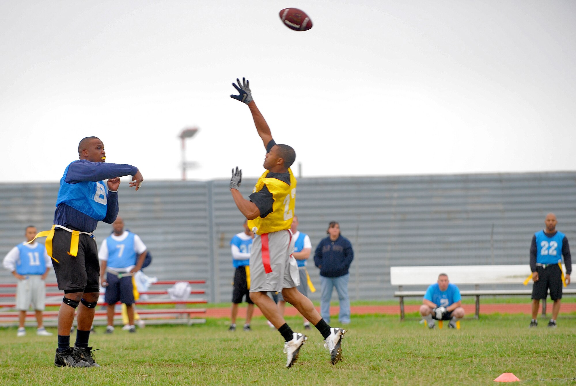 SPANGDAHLEM AIR BASE, Germany - Benjamin Wynn, 726th Air Mobility Squadron intramural football team quarterback, throws a 20-yard pass over the outstretched hands of a 52nd Equipment Maintenance Squadron defender during a flag football game Aug. 16. The 726th AMS won the game with a score of 9-0. (U.S. Air Force photo/Airman 1st Class Nick Wilson)