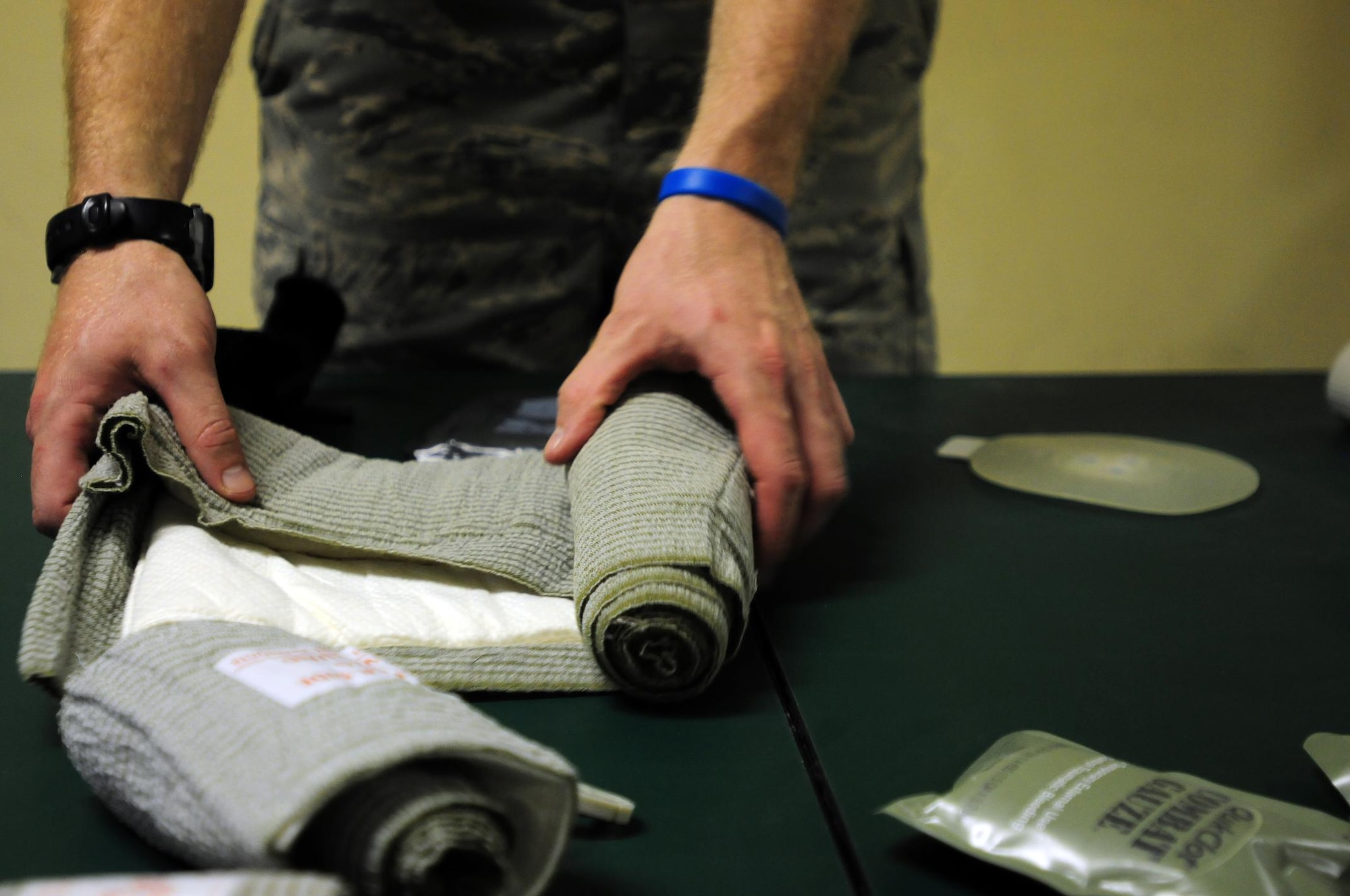 U.S. Air Force Senior Airman Jeffrey Marr, a Laghman Provincial Reconstruction Team medic, rolls up an abdominal dressing after conducting a Combat Lifesaver refresher course, Aug. 12, 2010. (U.S. Air Force photo by Staff Sgt. Ave I. Pele, Laghman Provincial Reconstruction Team Public Affairs)