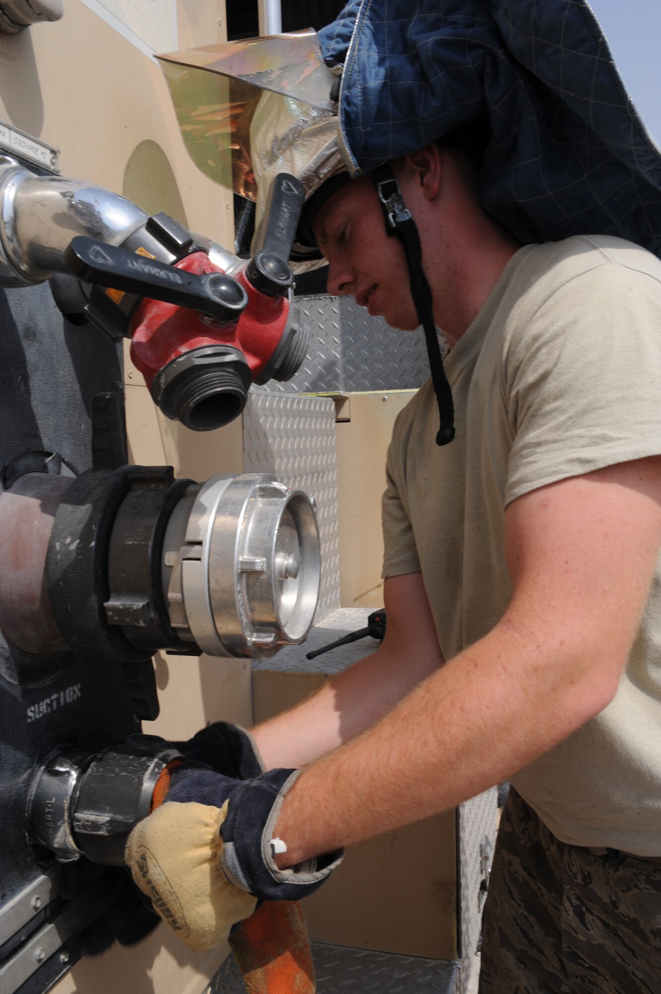 Airman 1st Class Justin Denno resupplies a firetruck with water at an undisclosed location in Southwest Asia August 17. Airman Denno is a firefighter with the 379th Expeditionary Civil Engineer Squadron and is deployed from Little Rock AFB, AR. (U.S. Air Force photo/Senior Airman Katie Gieratz) [RELEASED]