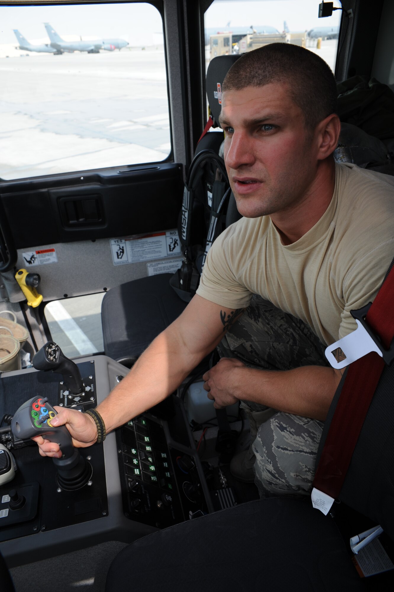 Senior Airman Scott Adams operates roof turret to spray down an aircraft at an undisclosed location in Southwest Asia, August 17. Airman Adams is a firefighter with the 379th Expeditionary Civil Engineer Squadron and is deployed from Pope AFB, N.C. (U.S. Air Force photo/Senior Airman Katie Gieratz)  [RELEASED]