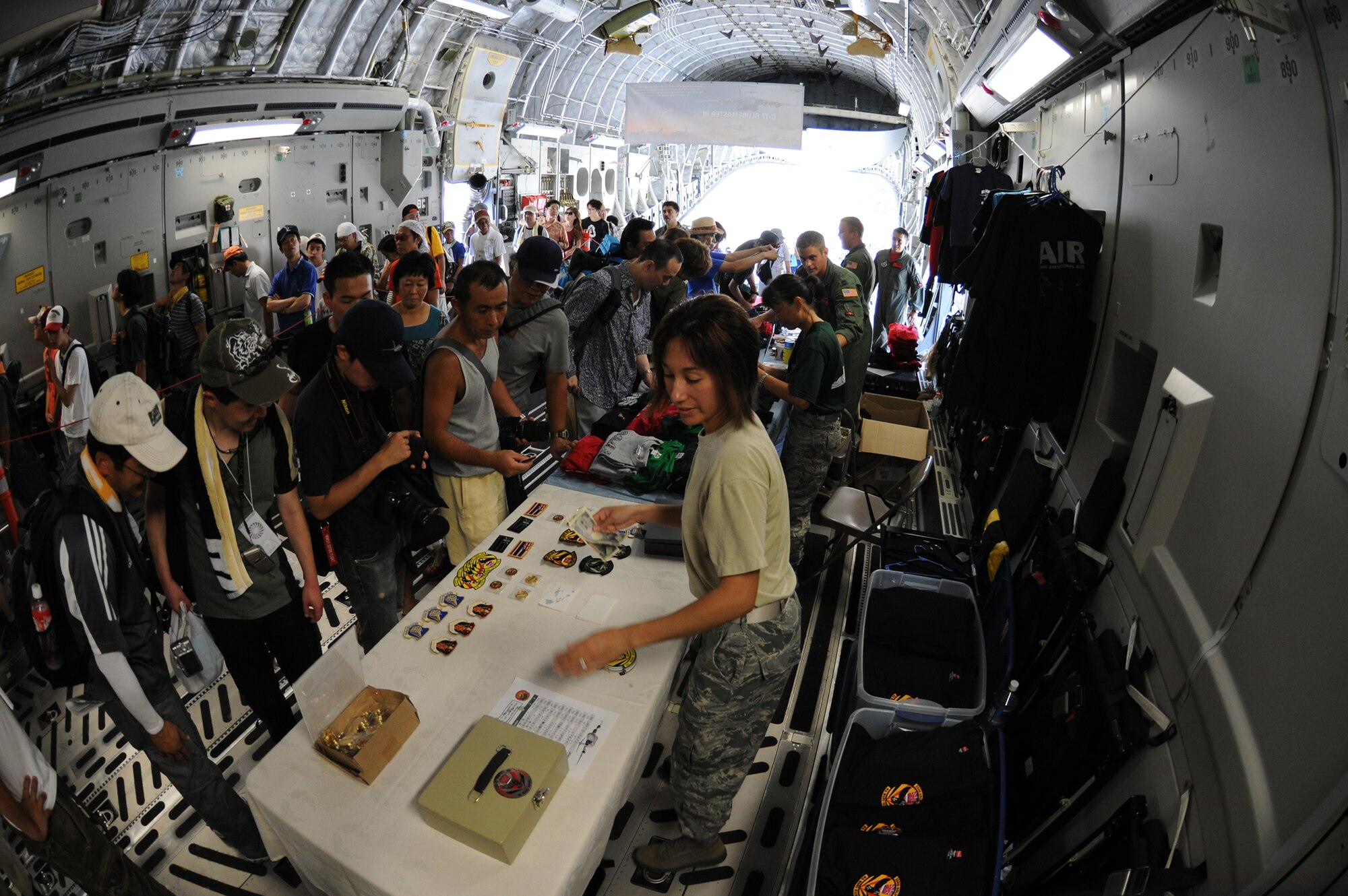YOKOTA AIR BASE, Japan -- Inside an air-conditioned C-17, visitors were able to buy patches and coins as well as sit in the pilot and co-pilot seats. More than 130,000 people attended the 2010 Yokota Air Base Japanese-American Friendship Festival, Aug. 21-22. The festival is held every year as a way to strengthen the ties with the local community. (U.S. Air Force photo by Staff Sgt Stacy Moless)