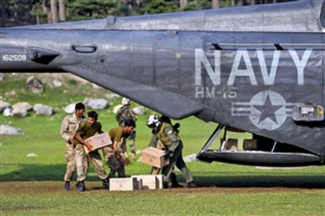 A U.S. Navy aircrew helps Pakistani soldiers load relief supplies aboard a U.S. Navy MH-53E Sea Dragon helicopter during humanitarian relief efforts in Pakistan's Khyber-Pakhtunkhwa province, Aug. 21, 2010. The U.S. crew, assigned to Helicopter Mine Countermeasures Squadron 15, is embarked aboard the amphibious assault ship USS Peleliu to support the Pakistan government in flooded regions of Pakistan.