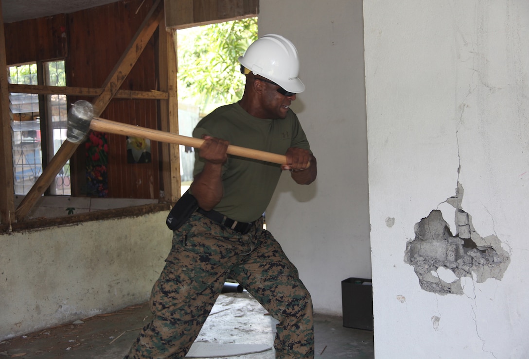 Gunnery Sgt. Joric Fowler, native of Baton Rouge, La., and utilities chief with 8th Engineer Support Battalion, Logistics Combat Element of Special-Purpose Marine Air-Ground Task Force Continuing Promise 2010, swings a sledge hammer into a wall to knock it down at the Center of Education and Nutrition in Bribri, Costa Rica, Aug. 24, 2010. Marines and Navy Seabees provided construction work at an engineer site to help Costa Ricans during CP10. Marines, sailors and USS Iwo Jima personnel are ported in Limon, Costa Rica, providing medical, dental, veterinary, community relations and engineering services to Costa Ricans as part of the CP10 mission during their deployment to the Caribbean, Central and South America.