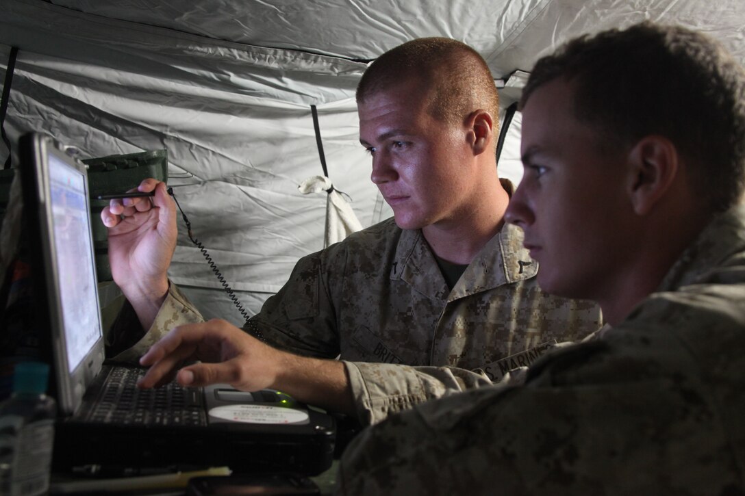 Pfc. Weston R. Britt and and Lance Cpl. Alex K. Arnston monitor communications activity during Marine Wing Communications Squadron 28’s field exercise at Marine Corps Outlying Field Camp Davis, N.C., Aug. 24. Britt is a lightweight multiband satellite terminal operator and Arnston is a ground mobile forces operator for MWCS-28.