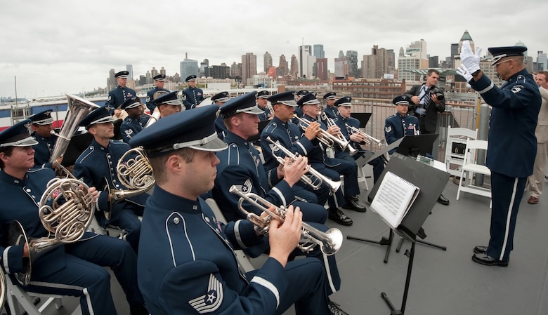 The Air Force Band performed during the Air Force Week New York City proclamation ceremony on the flightdeck of the USS Intrepid on Aug. 24, 2010. The event at the Intrepid Sea, Air & Space Museum was highlighted by a six-ship flyover by the USAF Thunderbirds. The Honorable Michael Donley, Secretary of the Air Force attended, along with General Raymond Johns, Commander of Air Mobility Command. The Police Commissioner of the City of New York, the Honorable Raymond Kelly, represented NYC. Mr. Greg Kelly of "Good Day New York" was emcee for this event. (U.S. Air Force photo/Lance Cheung)