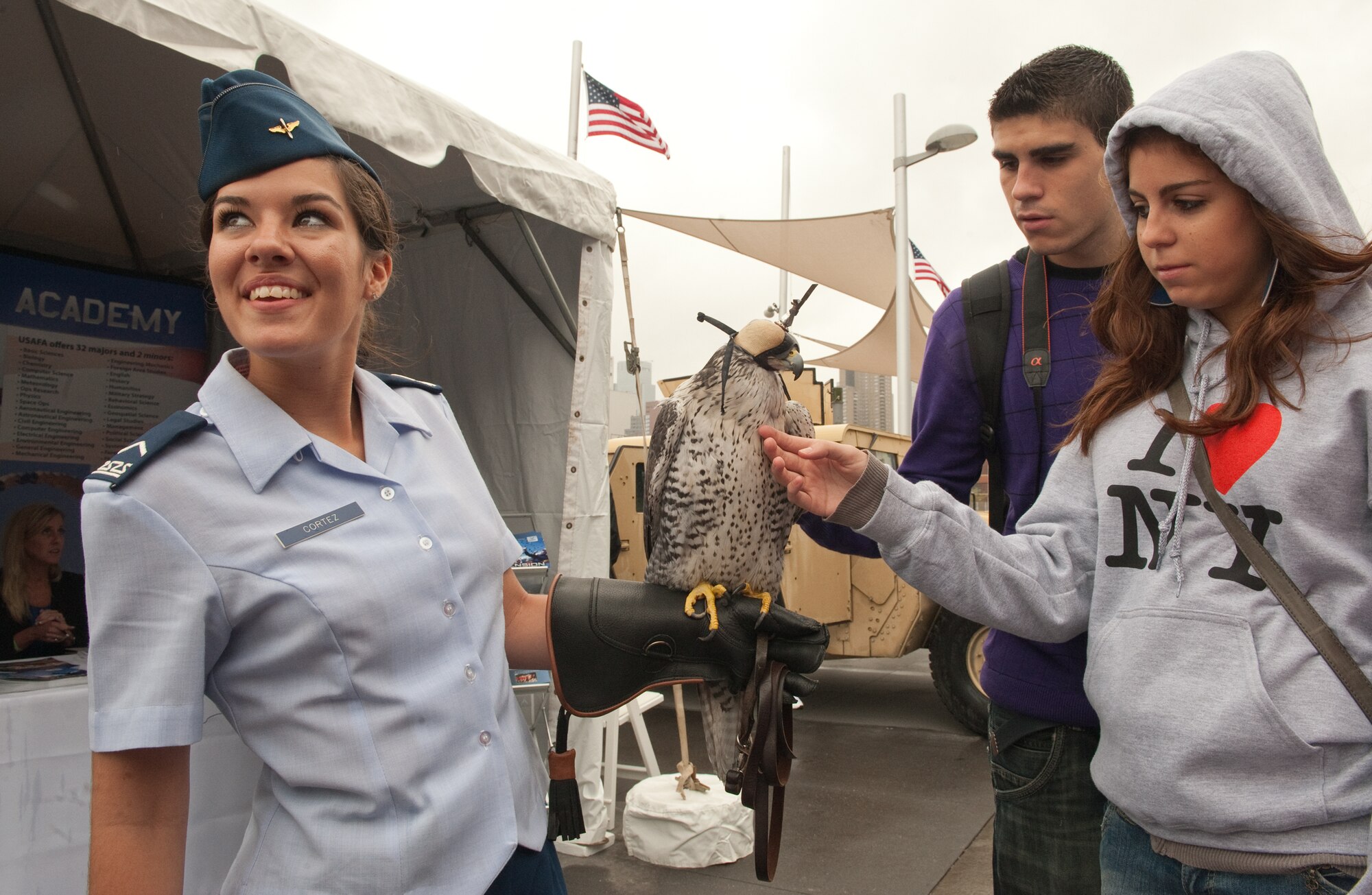Jordi Gil and his sister Paula, pet U.S. Air Force Academy falcon mascot "Destiny," while she is held by Cadet Third Class Danielle Cortez, during the Air Force Week New York City proclamation ceremony at the Intrepid Sea, Air and Space Museum Aug. 24, 2010, in New York. Jordi and Paula are visiting New York City from Barcelona, Spain. Throughout the week, Airmen will interact with the citizens of New York City to educate them about contributions the Air Force makes to national defense. Airmen will participate in a number of events including exhibits in Times Square, park clean-up projects in Brooklyn and the Bronx, and Air Force night at a New York Mets game. (U.S. Air Force photo/Lance Cheung)