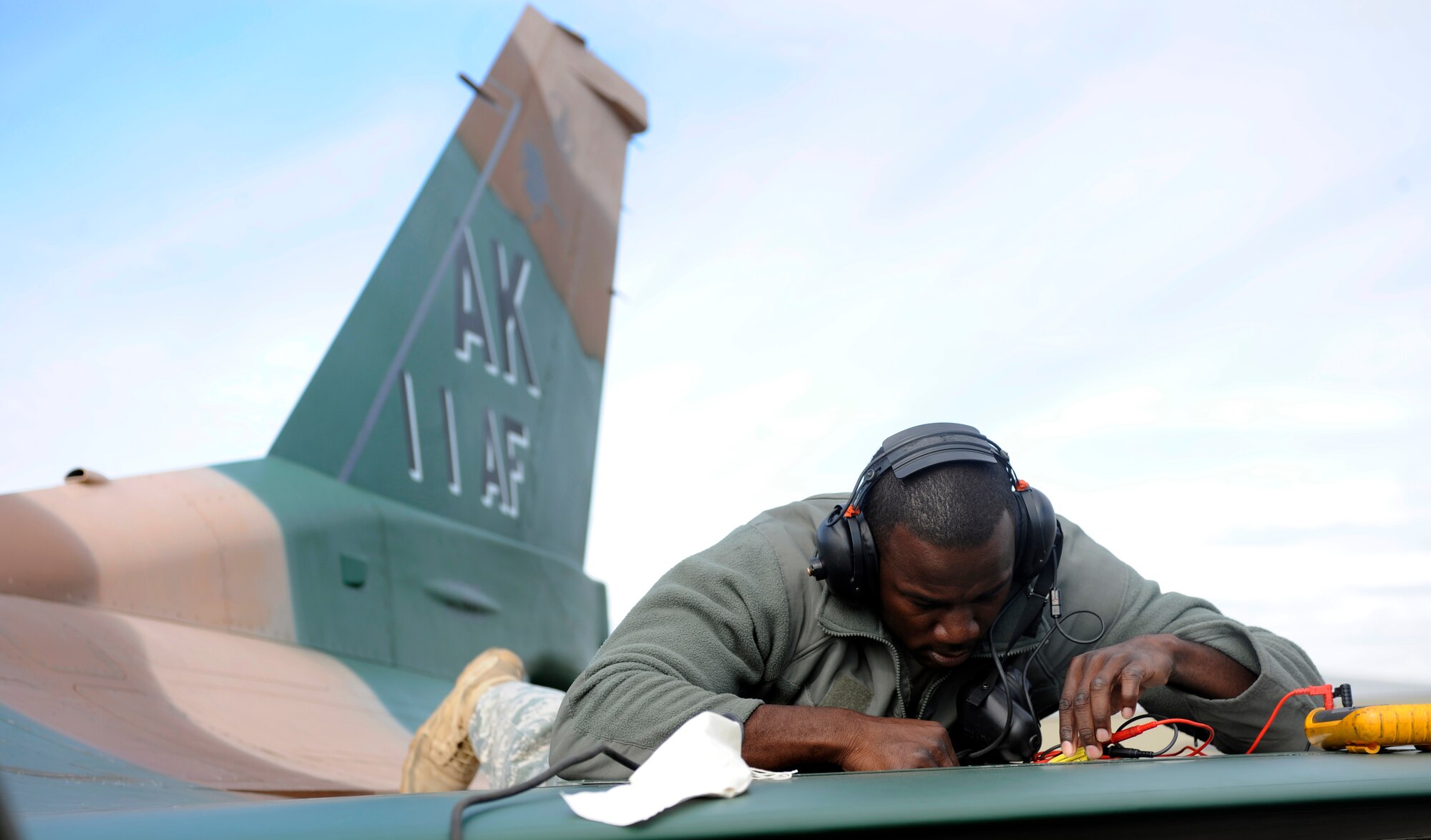 An Airman checks an electrical current during routine maintenance August 24, 2010, Eielson Air Force Base, Alaska. The Airman ensures the proper amount of electricity is flowing through the correct system. The Airman is assigned to the 354th Aircraft Maintenance Unit. (U.S. Air Force photo/Senior Airman Willard E. Grande II)