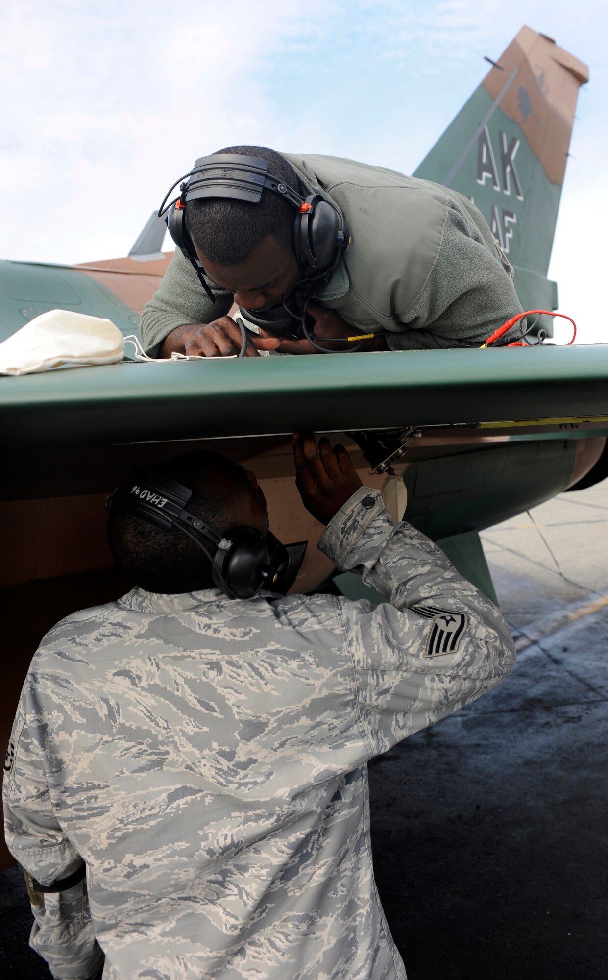 Airmen conduct a routine check August 24, 2010, Eielson Air Force Base, Alaska. The Airmen check the F-16 Fighting Falcon's electrical systems for preventative maintenance. The Airmen are assigned to the 354th Aircraft Maintenance Unit. (U.S. Air Force photo/Senior Airman Willard E. Grande II)