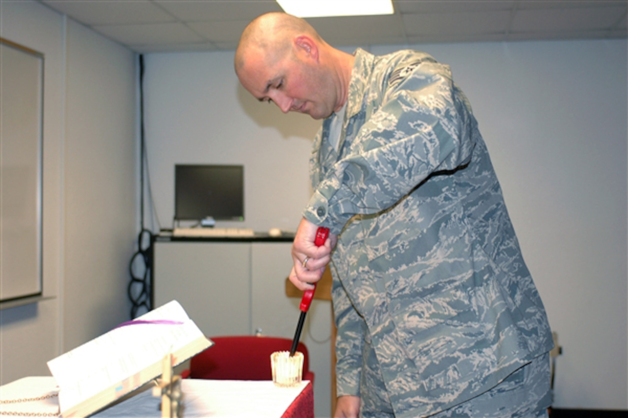 Staff Sgt. Trevor Harvey prepares for Catholic Mass on a drill weekend. Sergeant Harvey is a chaplain's assistant at the Arizona Air National Guard's 162nd Fighter Wing. (U.S. Air Force photo/Master Sgt. Desiree Twombly)