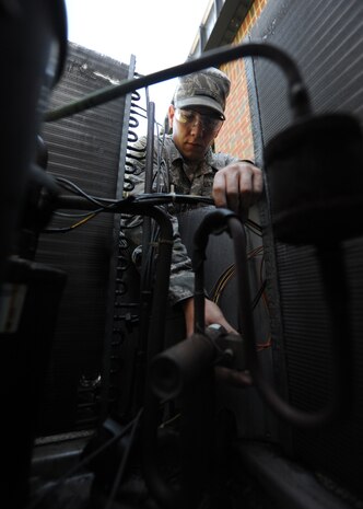 U.S. Air Force Airman Codye Miller dismantles the electrical panel on an air conditioning unit to gain access to its compressor Aug. 18,  2010, on Joint Base Charleston, S.C. Air conditioning units require periodic maintenance to replace old parts or fix damaged ones. Airman Miller is a heating, ventilation and air condition technician with the 628th Civil Engineer Squadron. (U.S. Air Force photo/Senior Airman Timothy Taylor) 
