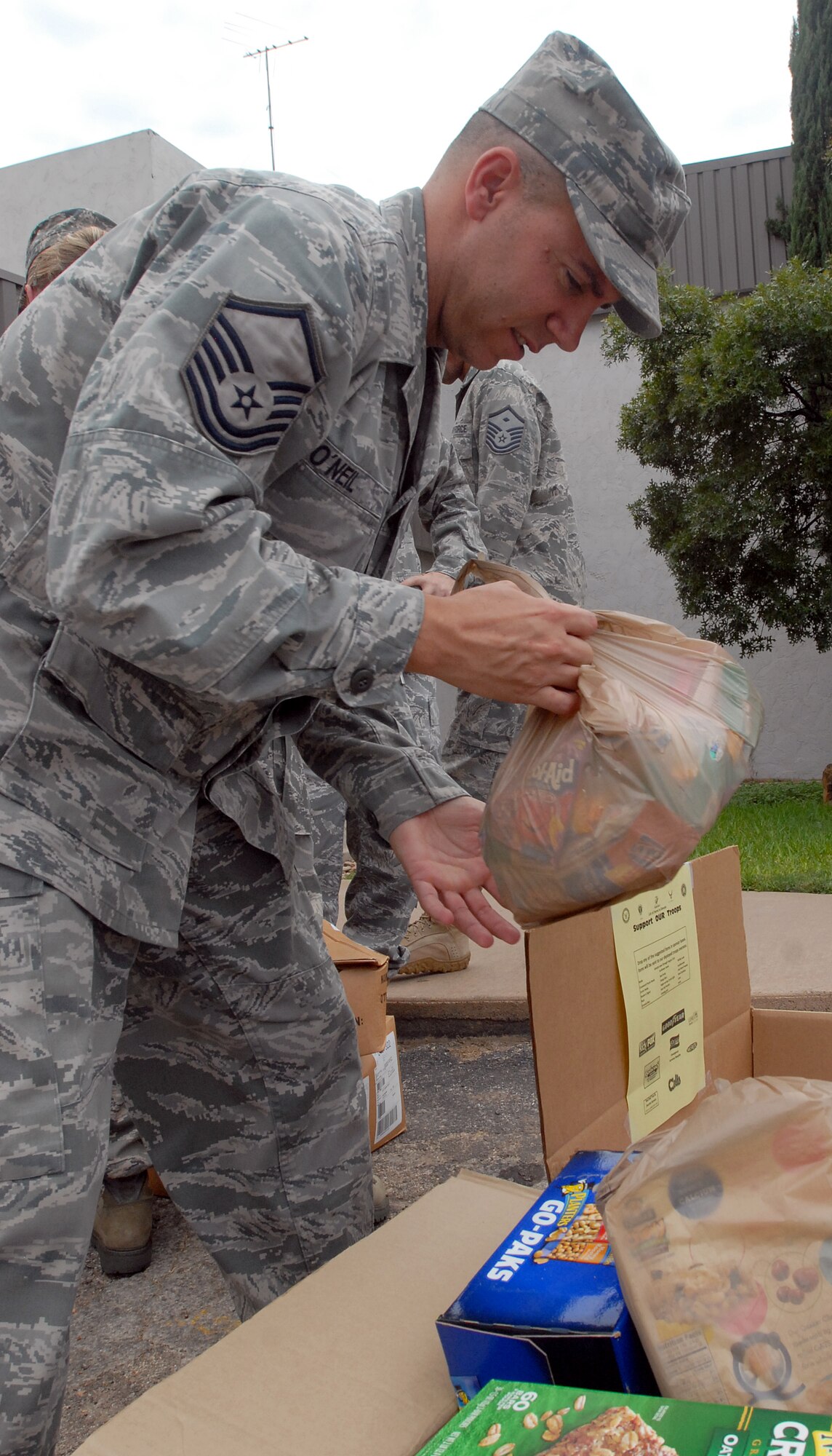 Master Sgt. Brandon O’Neil, 17th Force Support Squadron, sorts through donated snack foods  at a local television station Aug 18.  Supplies were collected by several local agencies and donated to the Goodfellow First Sergeant Council.  The donated items will be made into care packages and be sent to individuals deployed in Iraq or Afghanistan. (U.S. Air Force photo/Master Sgt. Randy Mallard)