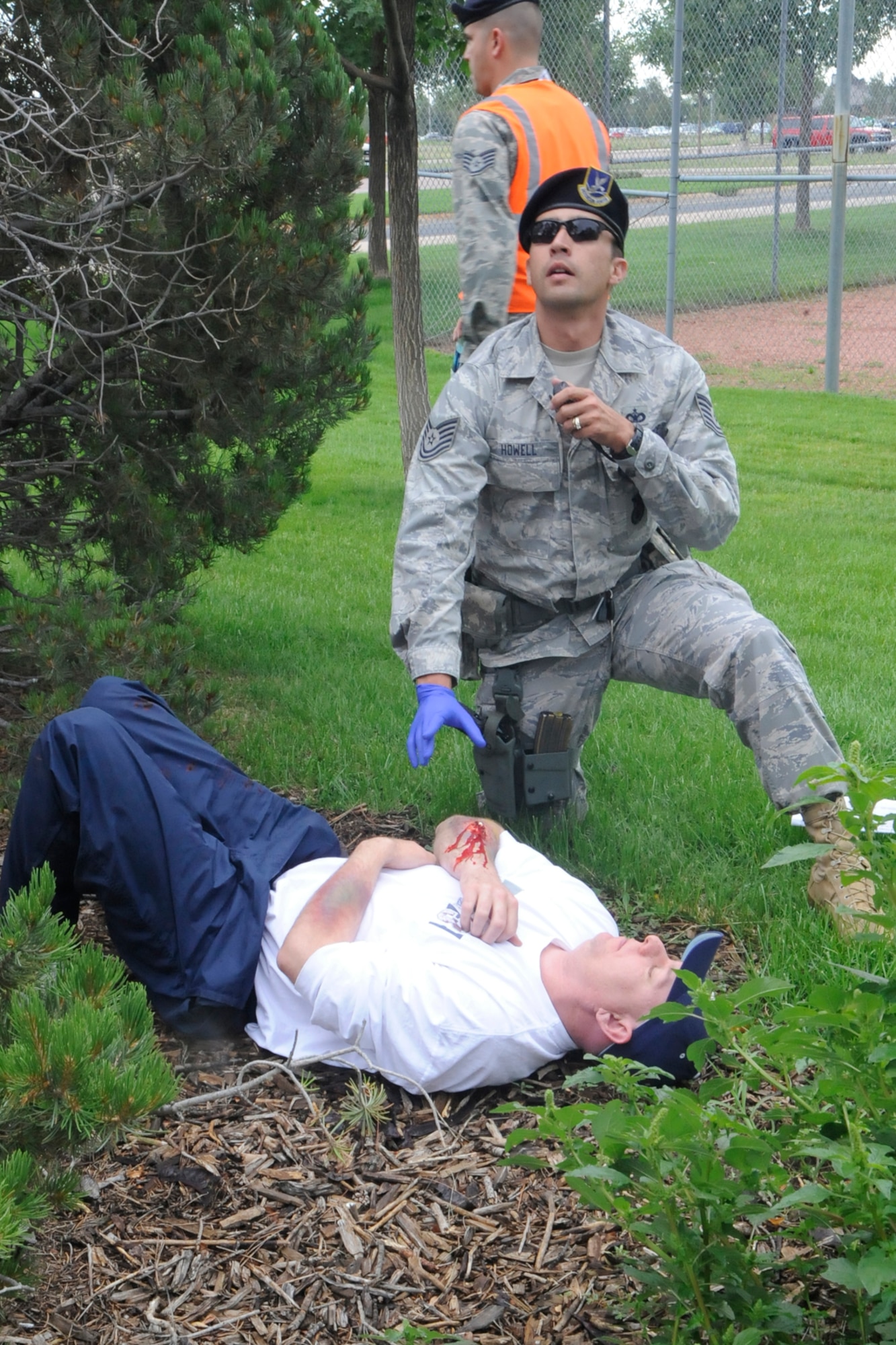 Staff Sgt. Steven Howell, 21st Security Forces Squadron, responds to a tornado victim during the quarterly Condor Crest exercise on Peterson Air Force Base Aug. 16 to 20. In the tornado scenario, base emergency responders rendered aid to more than 30 injured personnel. It was one of dozens of scenarios that played out during the exercise to test the base’s ability to survive and operate if it is attacked or hit by a natural disaster. (U.S. Air Force photo/Dennis Howk)