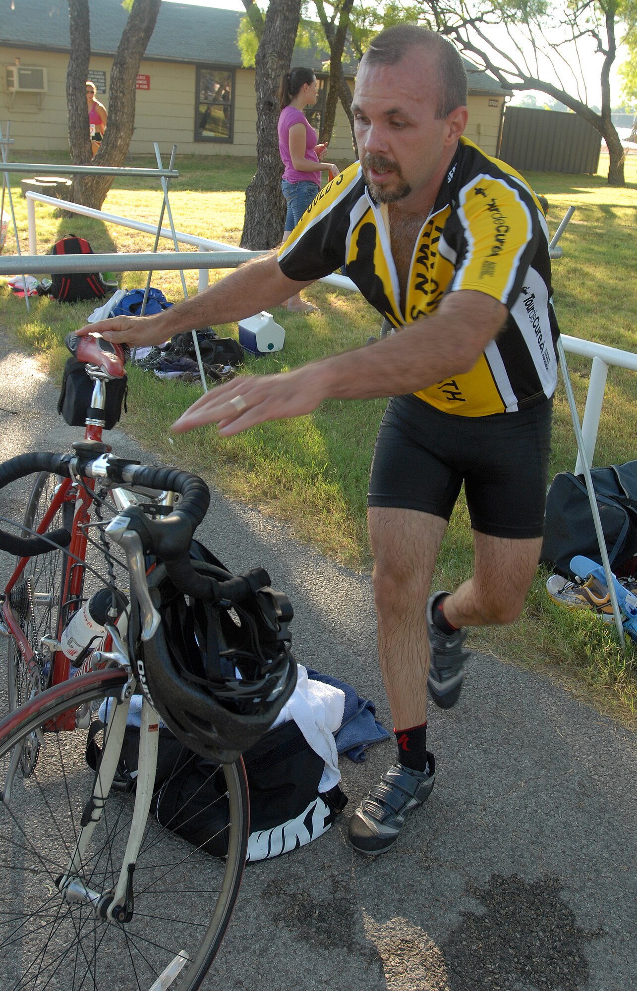 Kelly Dunn rushes to mount his bike for the 20 kilometer bike ride after completing the 400-meter swim during the 2010 Triathlon Aug. 21.  The triathlon, open to military and the community, was comprised of a 400-meter swim, 20-kilometer bike ride, and a 5-kilometer run.  (U.S. Air Force photo/ Master Sgt Randy Mallard)