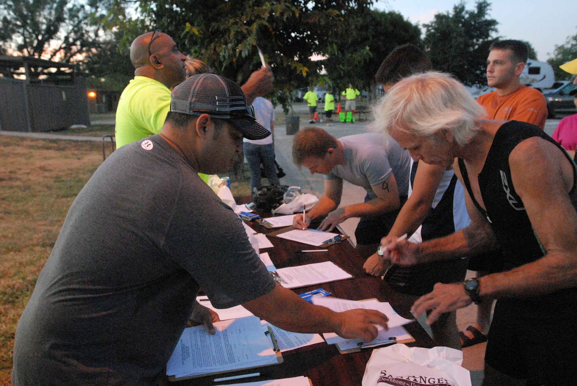 Staff members from the 17th Force Support Squadron help competitors sign in for the 2010 Triathlon Aug. 21.  The triathlon, open to military and the community, was comprised of a 400-meter swim, 20-kilometer bike ride, and a 5-kilometer run. (U.S. Air Force photo/ Master Sgt Randy Mallard)