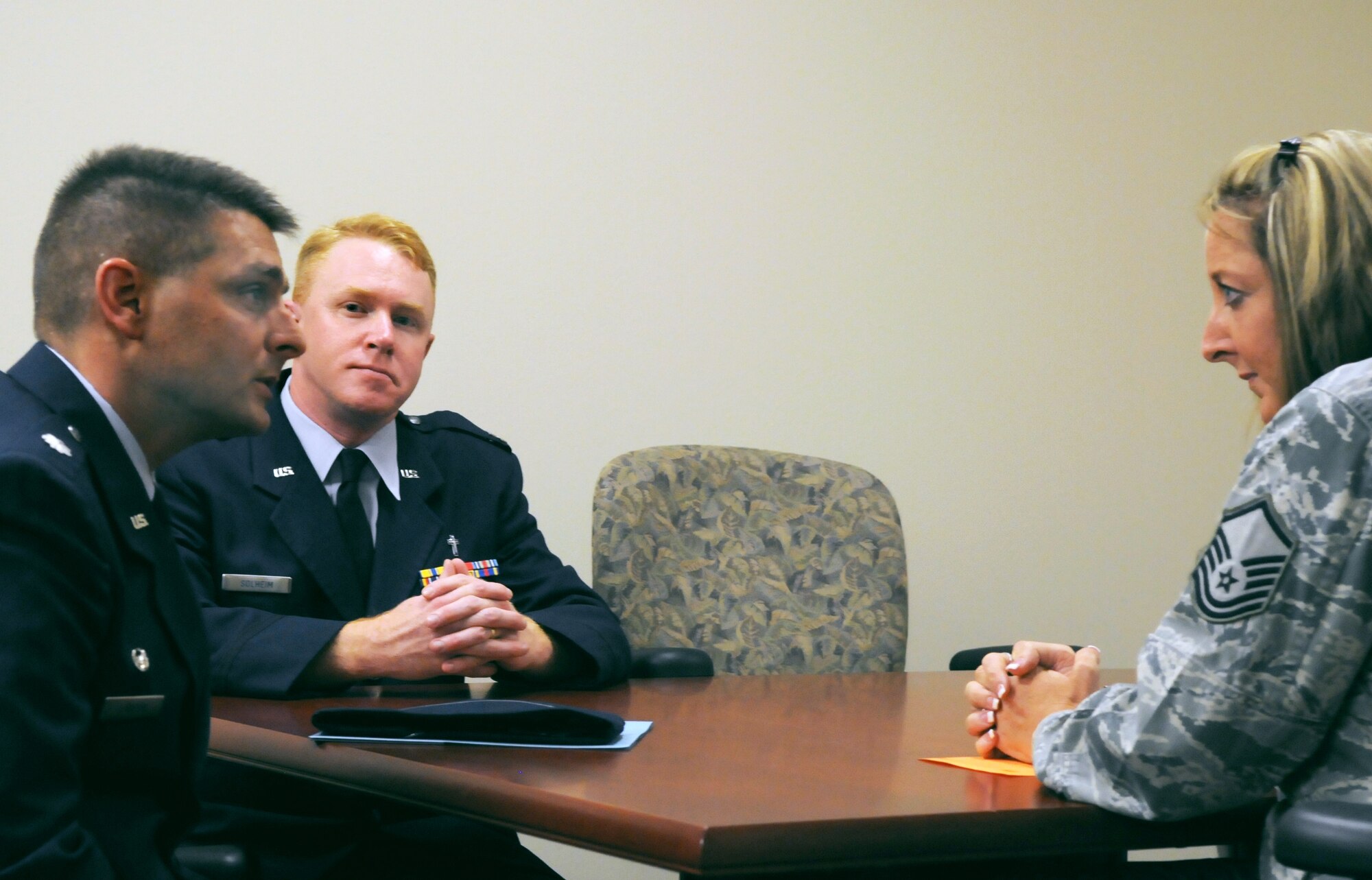 Lt. Col. Erick Lawson, 316th Training Squadron commander, and Chaplain (Capt.) Jeffrey Solheim, conduct a mock casualty death notification informing Master Sgt. Elly Stellmach, 17th Force Support Squadron, of her husband's death during the active shooter exercise Aug. 19. (U.S. Air Force photo/Airman 1st Class Clayton Lenhardt)