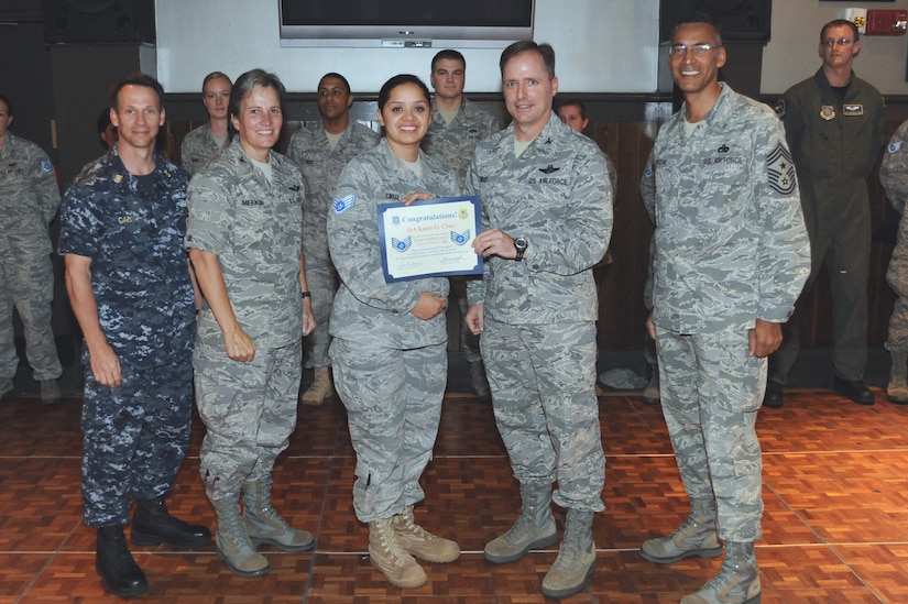 U.S. Air Force Senior Airman Karen Cruz is congratulated by Joint Base Charleston leadership during a promotion selection party Aug. 20, 2010. There were nearly 200 senior airmen selected for promotion base-wide. Airman Cruz was presented her certificate by 437th Airlift Wing Commander Col. John Wood, center right, 628th Air Base Wing Commander Col. Martha Meeker, center left, 437th Airlift Wing Command Chief Master Sgt. Terrence Greene, right, and Naval Weapons Station Charleston Command Master Chief Bill Cady. (U.S. Air Force photo/James M. Bowman)