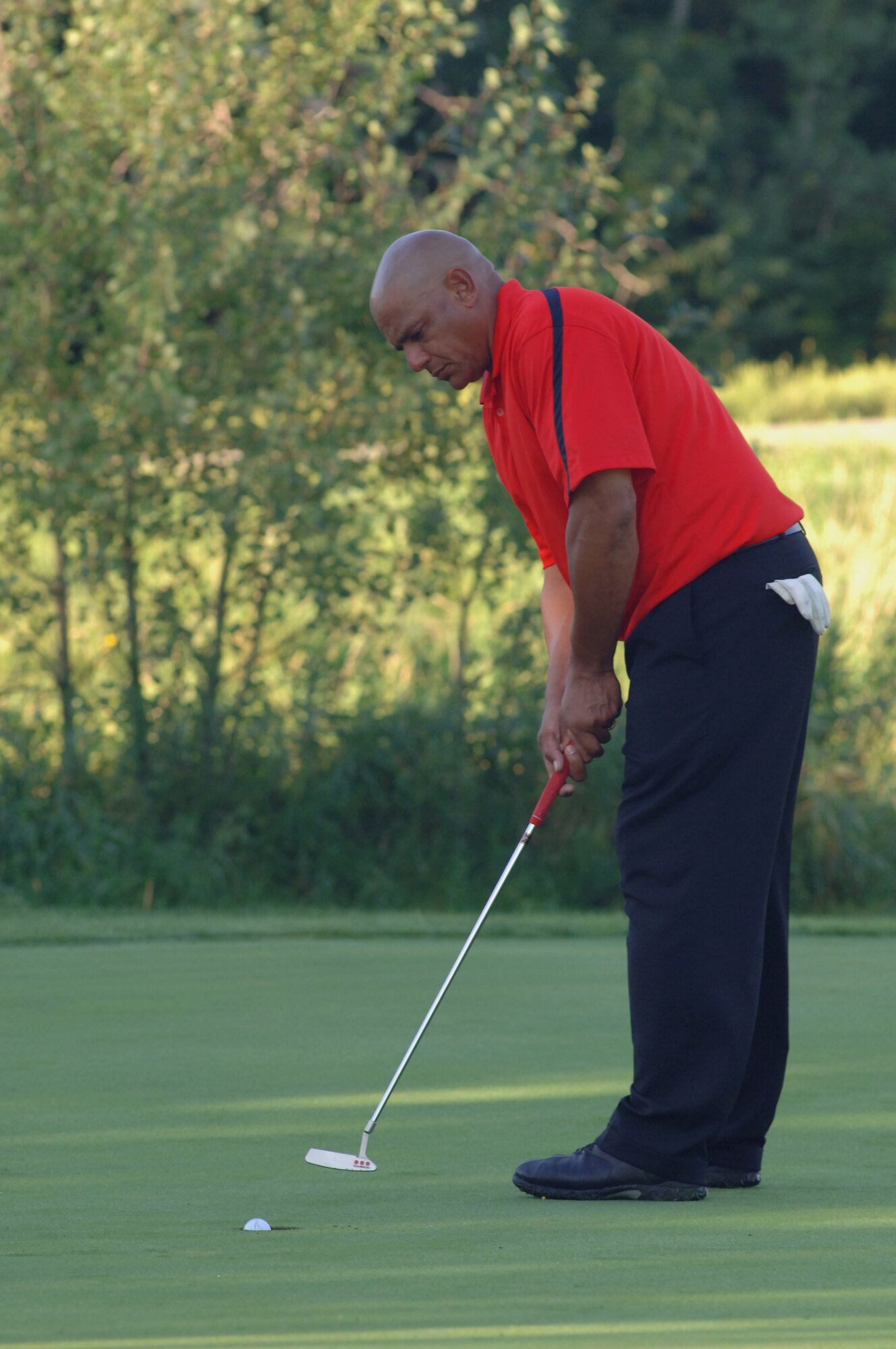 Phil Barfield sinks a putt Aug. 23 in Battle Lake, Minn. Mr. Barfield, and two other Grand Forks Air Force Base Airmen, traveled to Minnesota to take the Professional Golf Association’s Players Ability Test at Balmoral Golf Course. To pass the PGA’s test, players had to finish 36 holes of golf with a score of 153 or less. (U.S. Air Force photo by Staff Sgt. R. Michael Longoria)