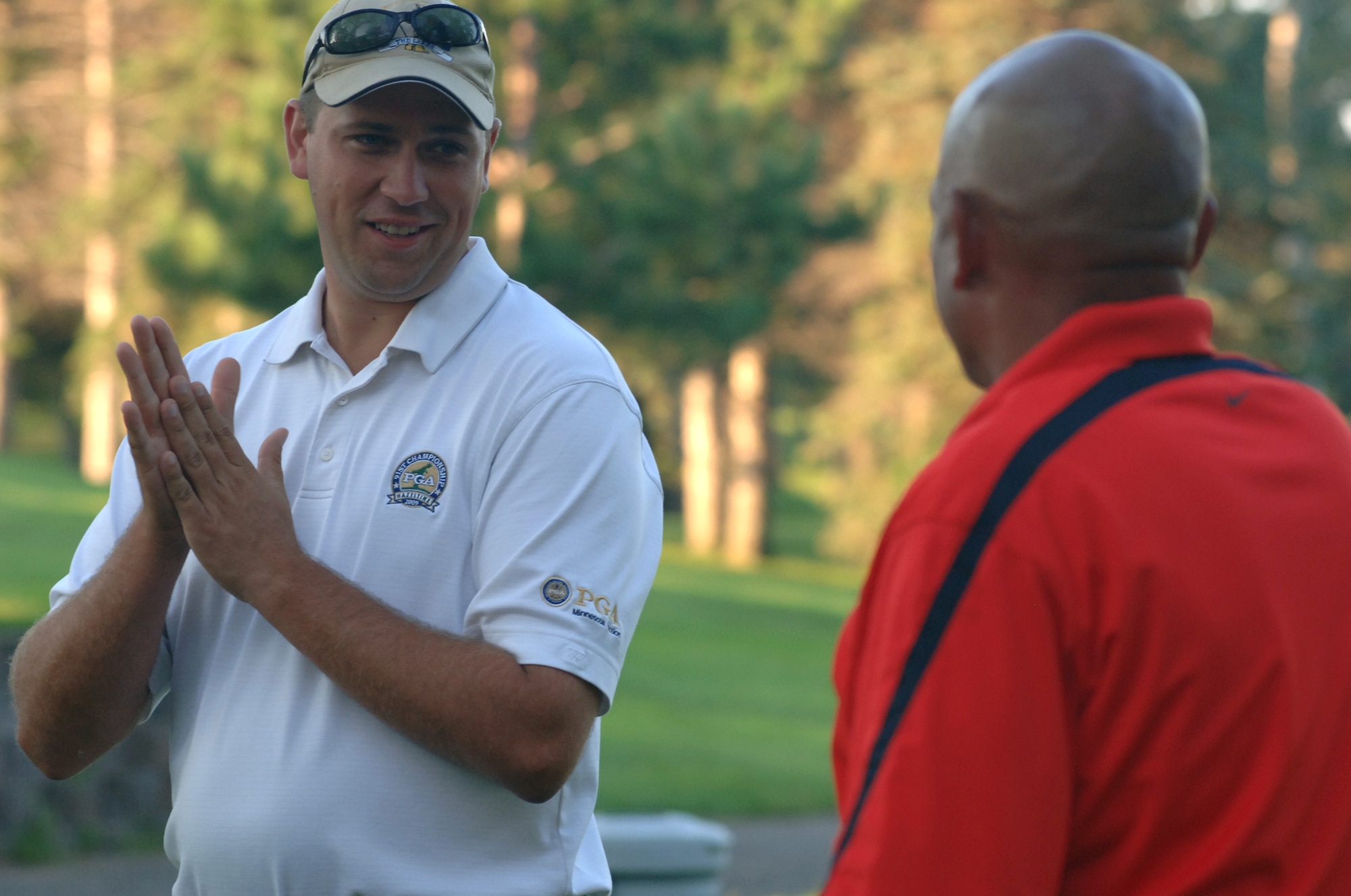 Greg Snow (left) explains a few rules to Phil Barfield before he tees off Aug. 23 in Battle Lake, Minn. Mr. Barfield, and two other Grand Forks Air Force Base Airmen, traveled to Minnesota to take the Professional Golf Association’s Players Ability Test at Balmoral Golf Course. To pass the PGA’s test, players had to finish 36 holes of golf with a score of 153 or less. Mr. Snow was the test administrator. (U.S. Air Force photo by Staff Sgt. R. Michael Longoria)
