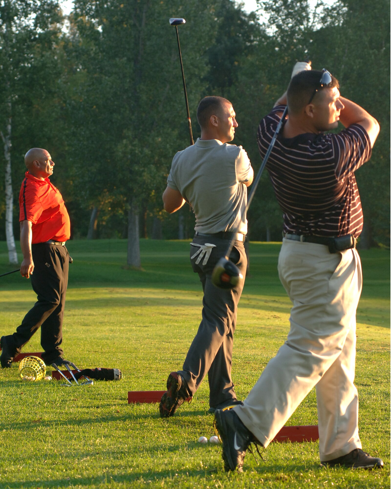 Phil Barfield (left), Senior Airman Johnathon A. Jones (center), 319th Civil Engineer Squadron, and Staff Sgt. Stephen W. Smith (right), Area Defense Counsel, watch their practice shots travel down the driving range Aug. 23 in Battle Lake, Minn. The three Grand Forks Air Force Base Airmen traveled to Minnesota to take the Professional Golf Association’s Players Ability Test at Balmoral Golf Course. To pass the PGA’s test, players had to finish 36 holes of golf with a score of 153 or less. (U.S. Air Force photo by Staff Sgt. R. Michael Longoria)