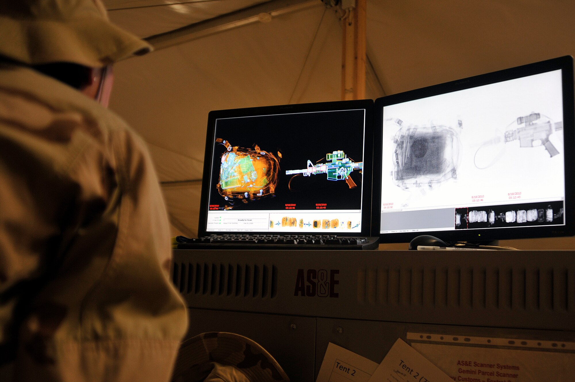 A customs and inspection sailor monitors a x-ray machine, Aug. 18, 2010, at Al Asad Air Base, Iraq. Navy customs scans each soldier to ensure there is no contraband. The Soldiers are redeploying as part of The U.S. Forces Responsible Drawdown of Forces to 50,000 troops by the end of August when Operation Iraqi Freedom ends, and Operation New Dawn begins. More than 90,000 troops have been redeployed during RDOF. (U.S. Air Force photo by Senior Airman Perry Aston) (Released)