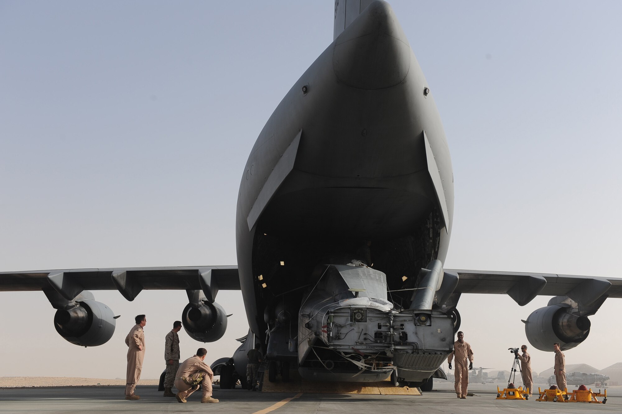 Aircrew assigned to the14th Airlift Squadron spot the U.S. Marines assigned to the 266th Medium Tilt Rotor Squadron, unloading a U.S. Marine Corps MH-53E Super Stallion out of a C-17A Globemaster III aircraft, Aug. 23, 2010 at Camp Bastion, Afghanistan. The mission is in support of the Pakistan flood relief efforts. (U.S. Air Force photo/Staff Sgt. Manuel J. Martinez)