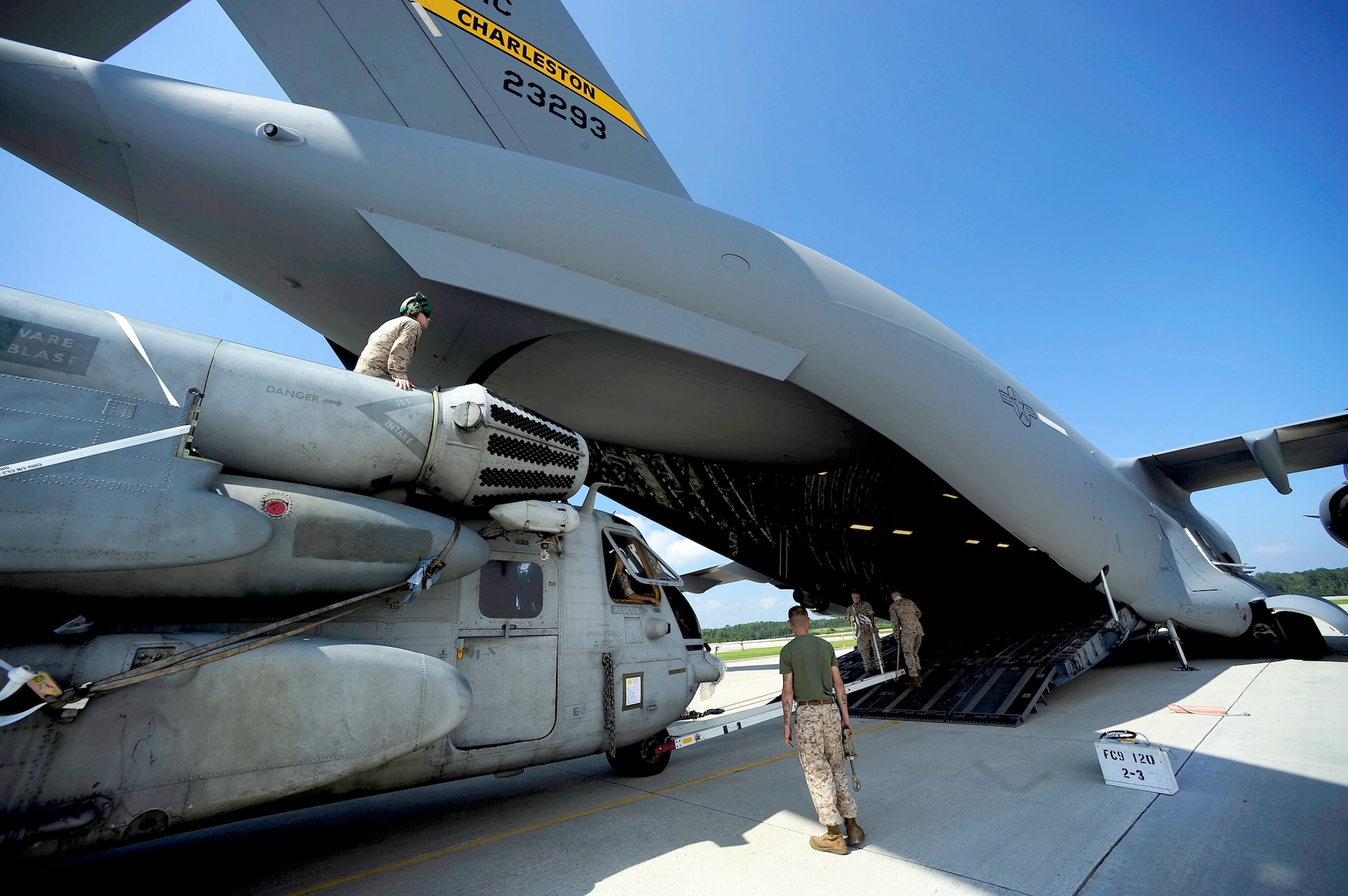 Airmen and Marines move a CH-53E Super Stallion onto a C-17 Globemaster III August 20, 2010, at Marine Corps Air Station Cherry Point, N.C.  The helicopter is one of four that will be used to supplement U.S. military rescue and relief efforts in the flood-affected areas of Pakistan. (U.S. Air Force photo/Staff Sgt. Kamaile O. Long)