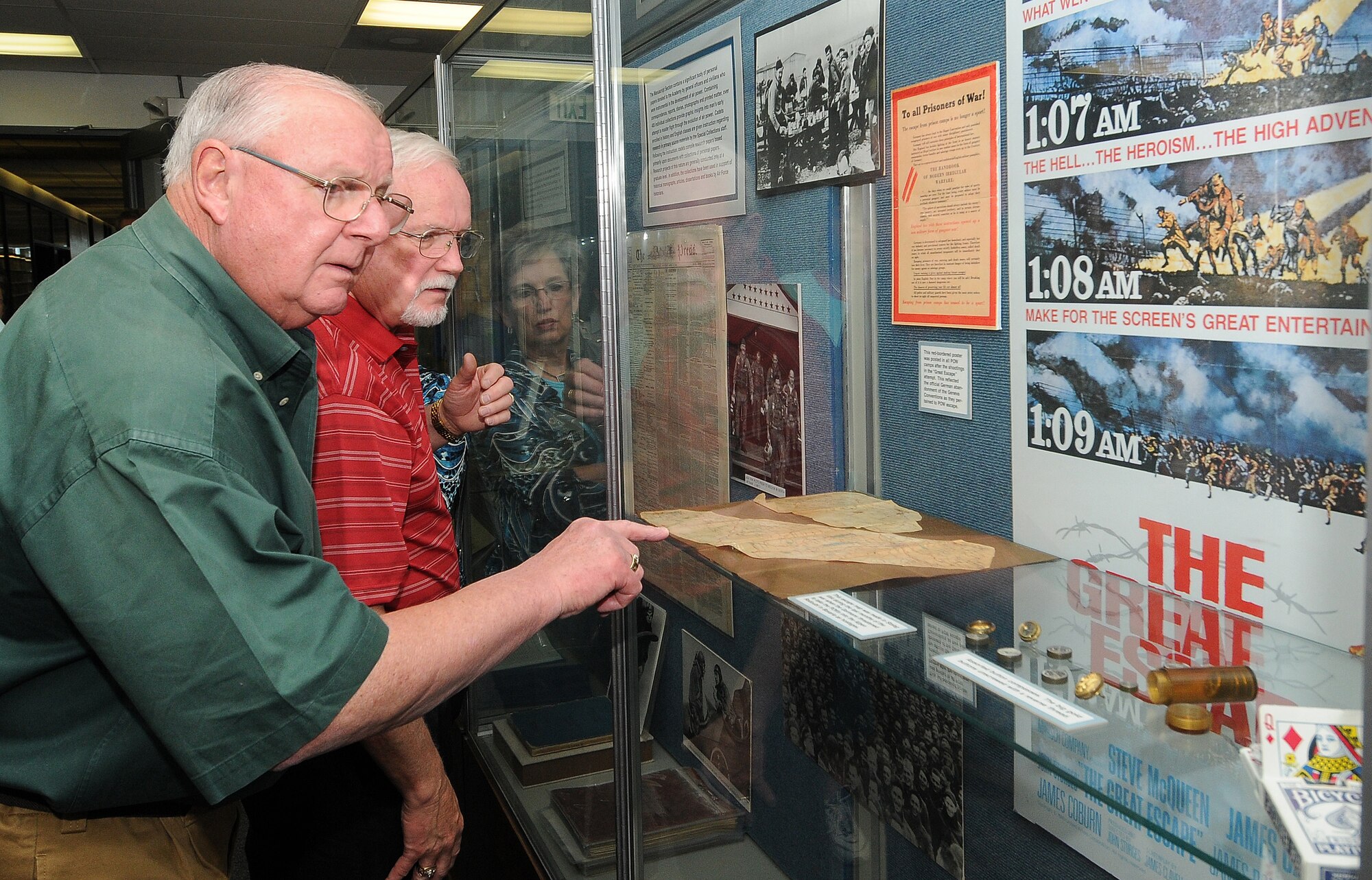 Jim Armature and James King look at a Stalag Luft III display outside the Gimbel room in the McDermott Library Aug. 20, 2010. The gentlemen were part of a group of about 60 people with the Royal Order of Jesters who visited the Academy. (U.S. Air Force photo/Rachel Boettcher)