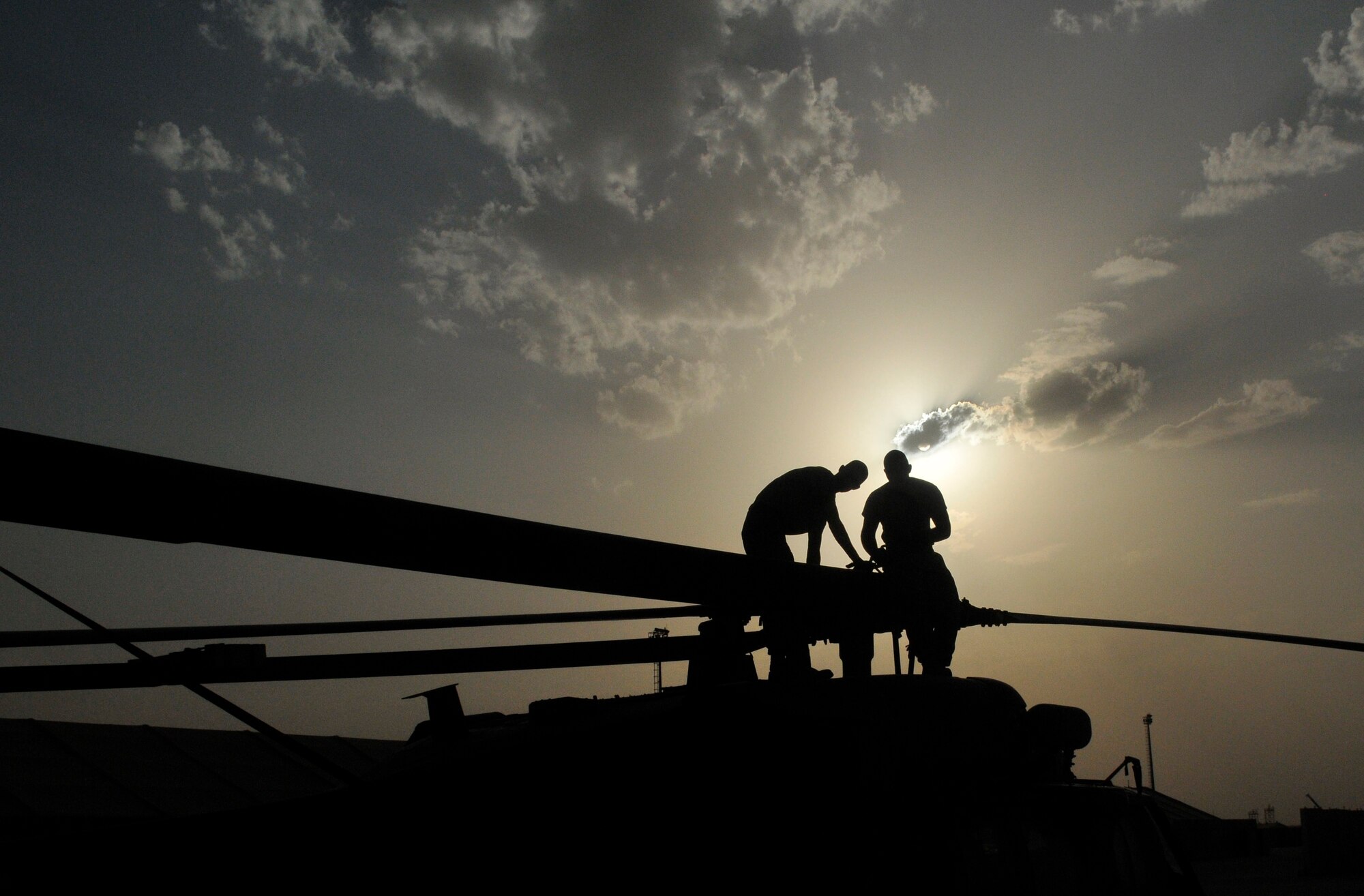 Airman 1st Class Tyler Lecates and Staff Sgt. Michael Burch, 332nd Expeditionary Aircraft Maintenance Squadron 64th Expeditionary Helicopter Maintenance Unit maintainers, prepare a HH-60 Pave Hawk helicopter main rotor for propeller alignment Aug. 12, 2010, Joint Base Balad, Iraq. The maintenance unit received the helicopter from a unit in Afghanistan. Airmen Lecates, a native of Allentown, Pa., is deployed from Moody Air Force Base, Ga. Sergeant Burch, a native of Black, Ala., is deployed from Nellis Air Force Base, Nev. (U.S. Air Force photo/Staff Sgt. Phillip Butterfield)