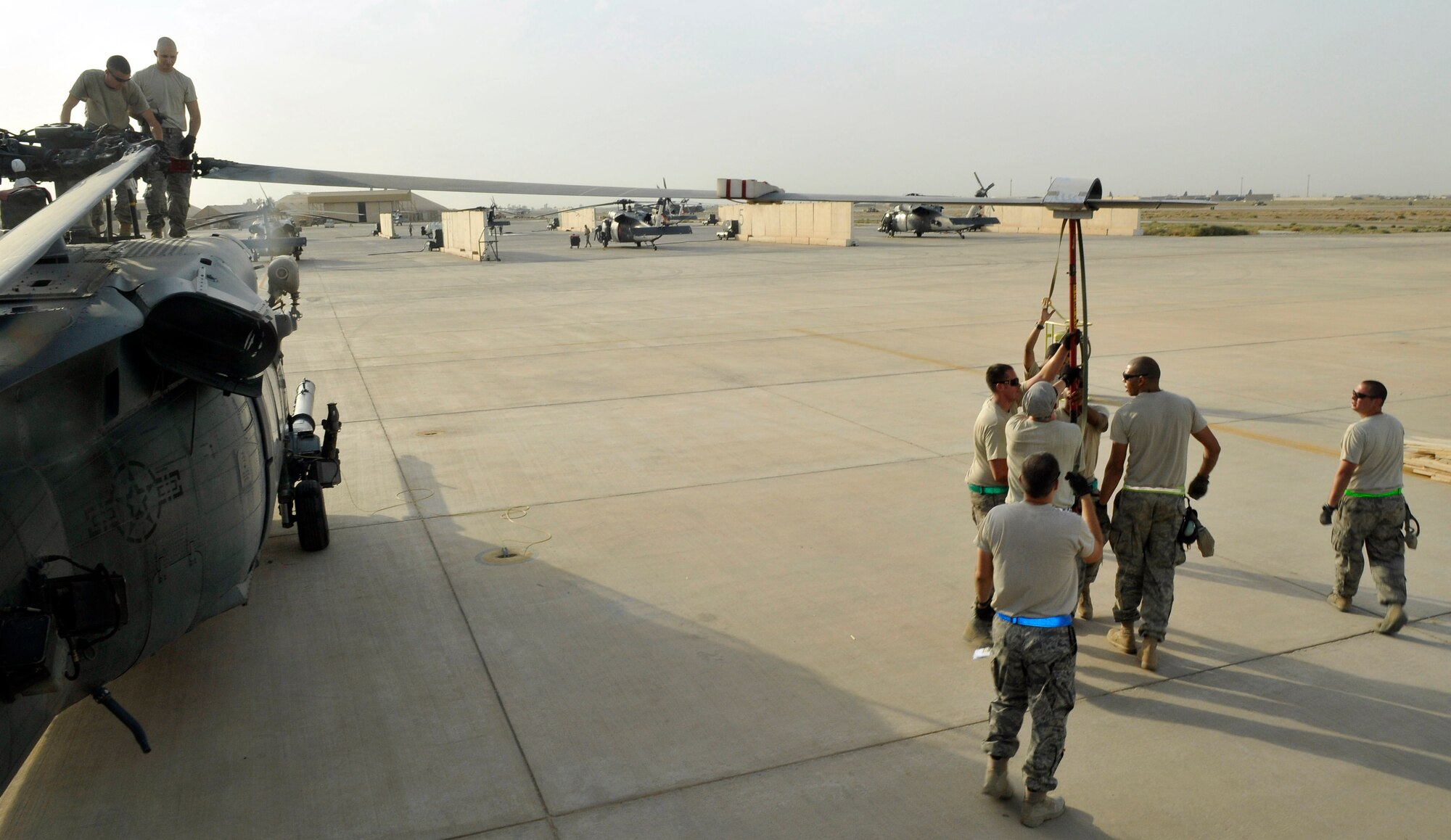 Airmen of the 332nd Expeditionary Aircraft Maintenance Squadron 64th Expeditionary Helicopter Maintenance Unit, unfold a propeller to a HH-60 Pave Hawk helicopter after receiving the helicopter from a unit in Afghanistan Aug. 12, 2010, Joint Base Balad, Iraq. The HH-60 is a four-propeller helicopter that replaced the HH-3E Jolly Green Giant in 1981. (U.S. Air Force photo/Staff Sgt. Phillip Butterfield)
