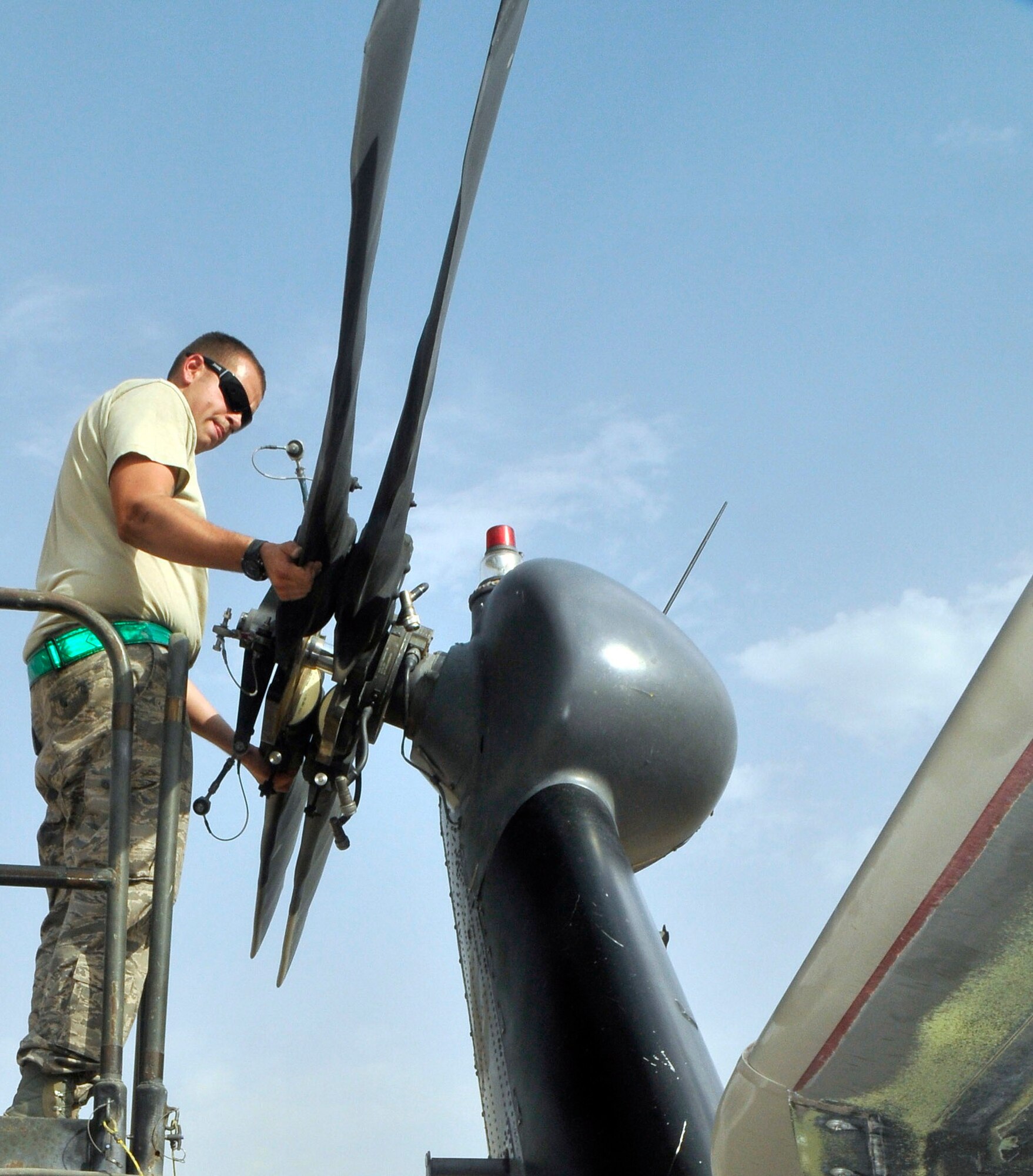 Senior Airman Ronald Hastings, 332nd Expeditionary Aircraft Maintenance Squadron 64th Expeditionary Helicopter Maintenance Unit crew chief, unfolds the tail rotor of a HH-60 Pave Hawk helicopter after Airmen received it from a unit in Afghanistan Aug. 12, 2010, Joint Base Balad, Iraq. The H-60 family of helicopters can be folded for ease of transportation. Airman Hastings, a native of Pittsburgh, Pa., is deployed from Nellis Air Force Base, Nev. (U.S. Air Force photo/Staff Sgt. Phillip Butterfield)