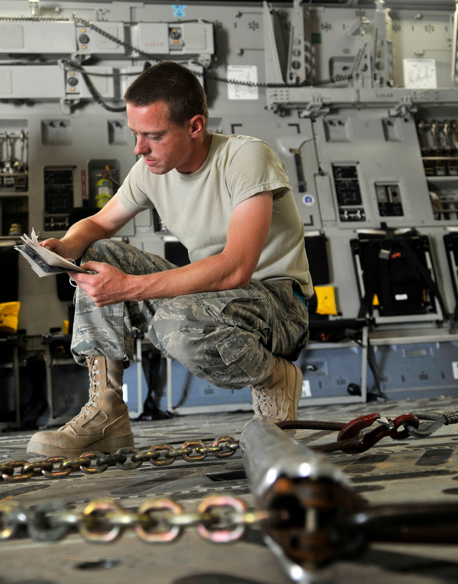 Staff Sgt. Keith McCarthy, 332nd Expeditionary Aircraft Maintenance Squadron 64th Expeditionary Helicopter Maintenance Unit H-60 crew chief, reads a technical order that recommends the best way to off-load a HH-60 Pave Hawk helicopter from a C-17 Globemaster III Aug. 12, 2010, Joint Base Balad, Iraq. The helicopter is part of an exchange program that swaps low maintenance-hour aircraft for high maintenance-hour aircraft. Sergeant McCarthy, a native of El Paso, Texas, is deployed from Moody Air Force Base, Ga. (U.S. Air Force photo/Staff Sgt. Phillip Butterfield)