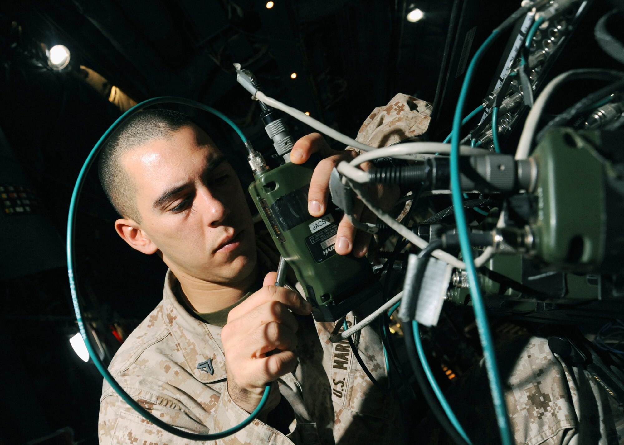 U.S. Marine Cpl. Joseph Colby checks the presets and frequencies of radios on a joint airborne battle staff detachment C-130 prior to a mission Nov. 24, 2009. The JABS is a joint operation focused on providing airborne communications support to ground forces. Corporal Colby is an air control electronics operator with the 777th Expeditionary Airlift Squadron. (U.S. Air Force photo/Senior Airman Christopher Hubenthal)