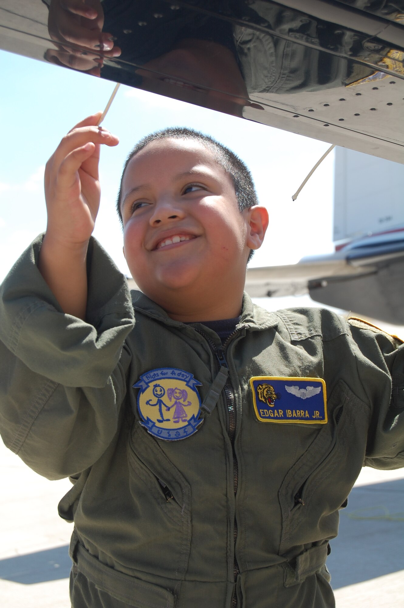 LAUGHLIN AIR FORCE BASE, Texas – Del Rio native Edgar Ibarra Jr., touches a static wick on a T-6 aircraft Aug. 20 during his “Pilot for a Day” tour. The “Pilot for a Day” program gives terminally ill or disabled children the opportunity to experience a day in the life of a pilot at Laughlin. 8-year-old Edgar has spina bifida and his love of all things mechanical made him a perfect candidate. (U.S. Air Force Photo by Staff Sgt. Desiree Economides)