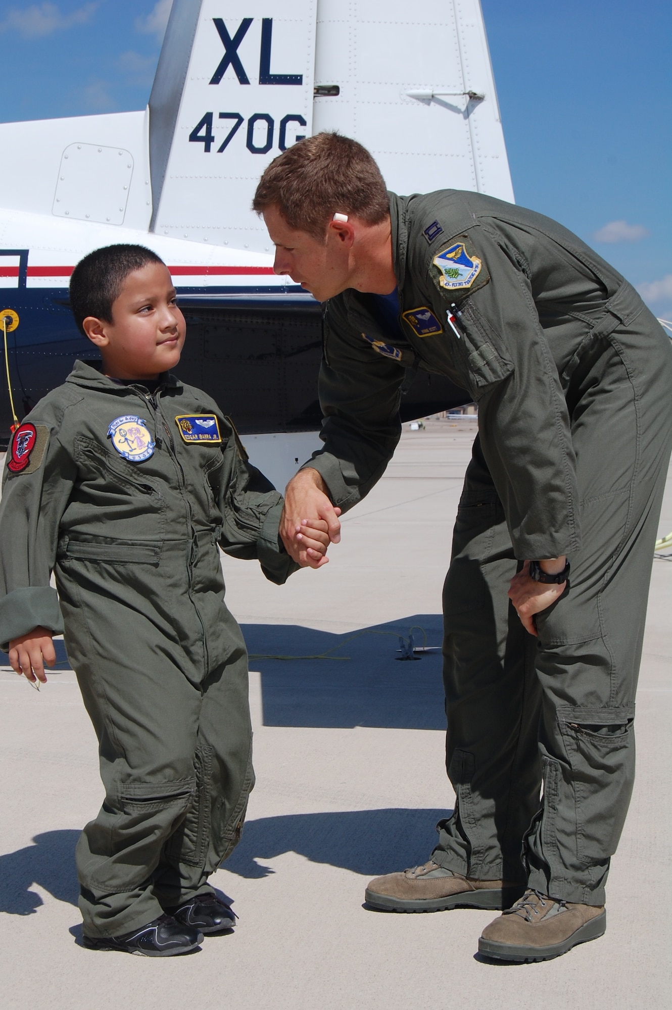 LAUGHLIN AIR FORCE BASE, Texas – Capt. Winfield Scott, a T-6 instructor pilot in the 85th Flying Training Squadron, talks to 8-year-old Edgar Ibarra Jr. during “Pilot for a Day” Aug. 20. The “Pilot for a Day” program gives terminally ill or disabled children the opportunity to experience a day in the life of a pilot at Laughlin. Edgar, a Del Rio native, has spina bifida and his love of all things mechanical made him a perfect candidate. (U.S. Air Force Photo by Staff Sgt. Desiree Economides)