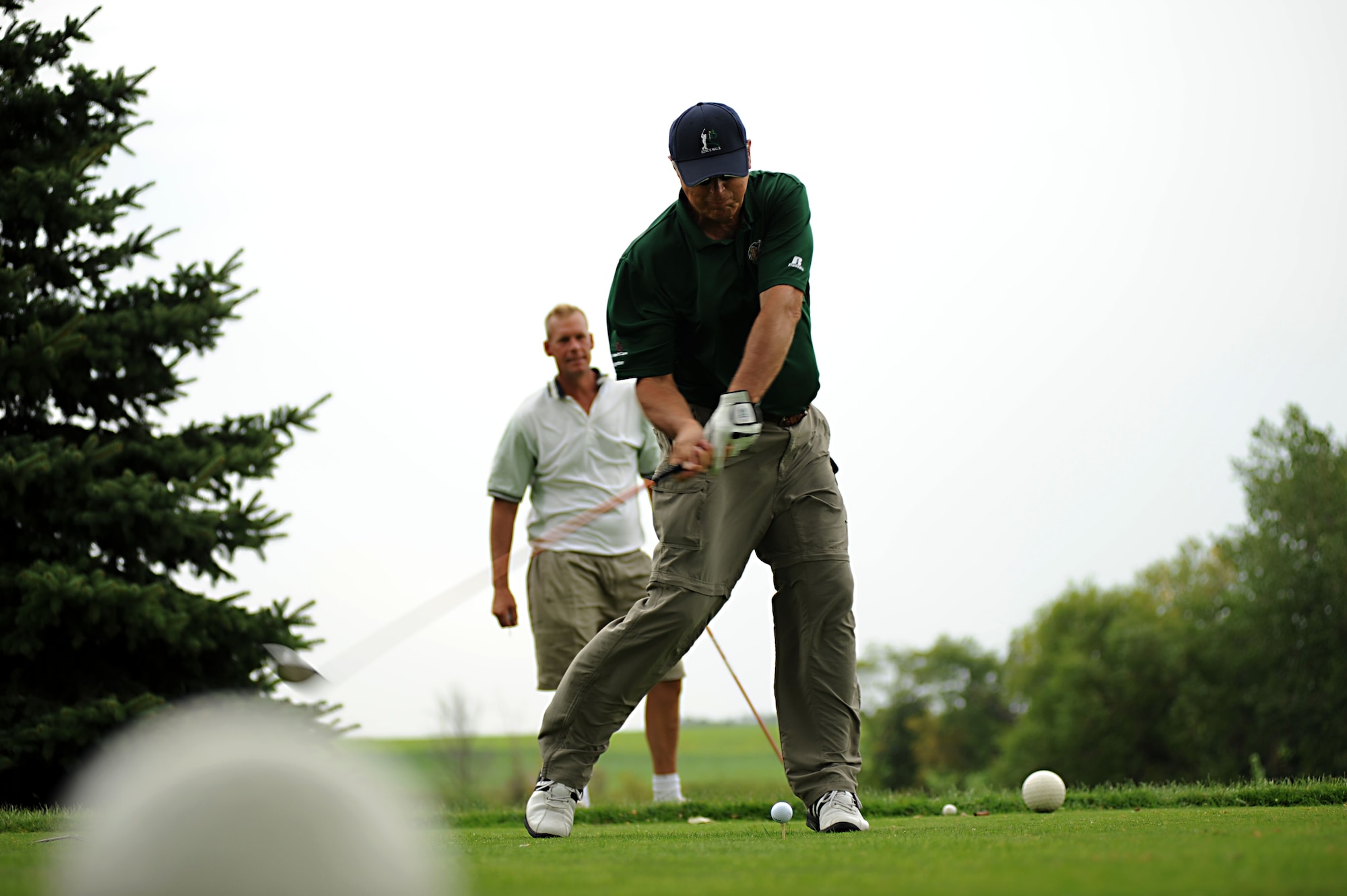 Chief Master Sgt. Dave Carlson, 319th Air Refueling Wing command chief, watches Dick Olson tee off Aug. 23 during the Military Affairs Committee Golf Tournament at Grand Forks Country Club, N.D. The MAC Golf Tournament is an annual golf scramble consisting of two tournaments, one on Grand Forks AFB and one in the city of Grand Forks. Each four-man team is made up of both base personnel and members of the Grand Forks community. The event has been taking place since the 1980’s and continues to be a unique way for base and community members to interact. (U.S. Air Force photo by Senior Airman Amanda N. Stencil)