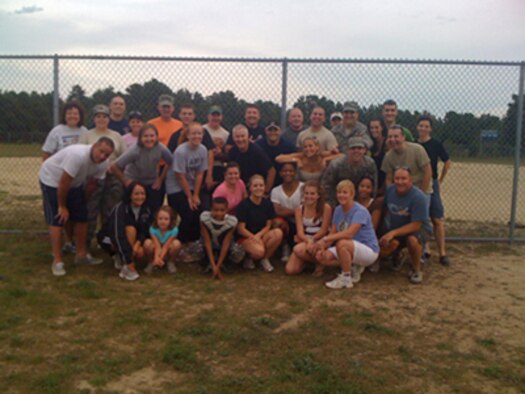OTIS AIR NATIONAL GUARD BASE, Mass. -- Airmen of the 102nd Medical Group pose for a photograph after competing in the group's second-annual Officers vs. Enlisted softball game, Aug. 21.  The officers won the game 14-10, exacting some revenge for the enlisted team's win in the group's inaugural softball game in 2009.  (U.S. Air Force photo by Tech. Sgt. Sarah Perry)