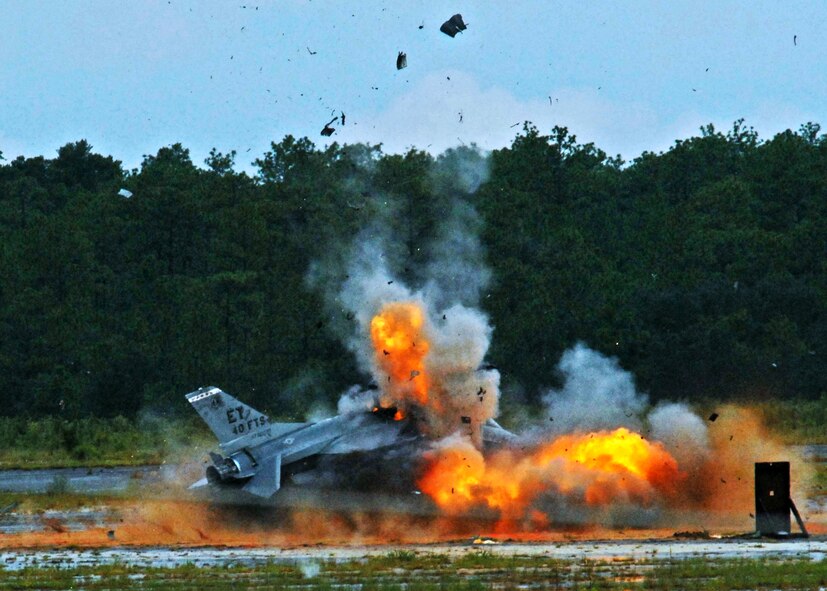 An F-16 Fighting Falcon explodes, sending debris and shrapnel into the air Aug. 19 on the Eglin Air Force Base range.  The explosion was a static test of the flight termination system to be used in the QF-16.  The purpose was to demonstrate that the FTS design will be sufficient to immediately terminate the flight of a QF-16, as well as determine a range safety debris footprint.  (U.S. Air Force photo/Samuel King Jr.)