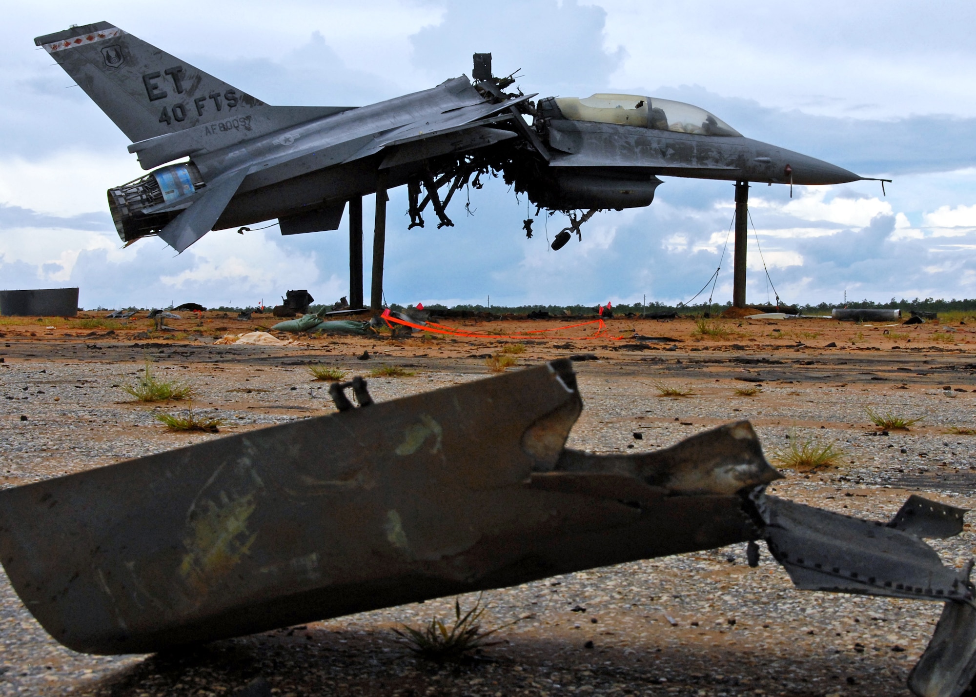 An explosion ripped the F-16 Fighting Falcon into two pieces and scattered debris across the Eglin Air Force Base range Aug. 19.  The explosion was a test of the flight termination system to be used in the QF-16.  The purpose was to demonstrate that the FTS design will be sufficient to immediately terminate the flight of a QF-16, as well as determine a range safety debris footprint.  (U.S. Air Force photo/Samuel King Jr.)
