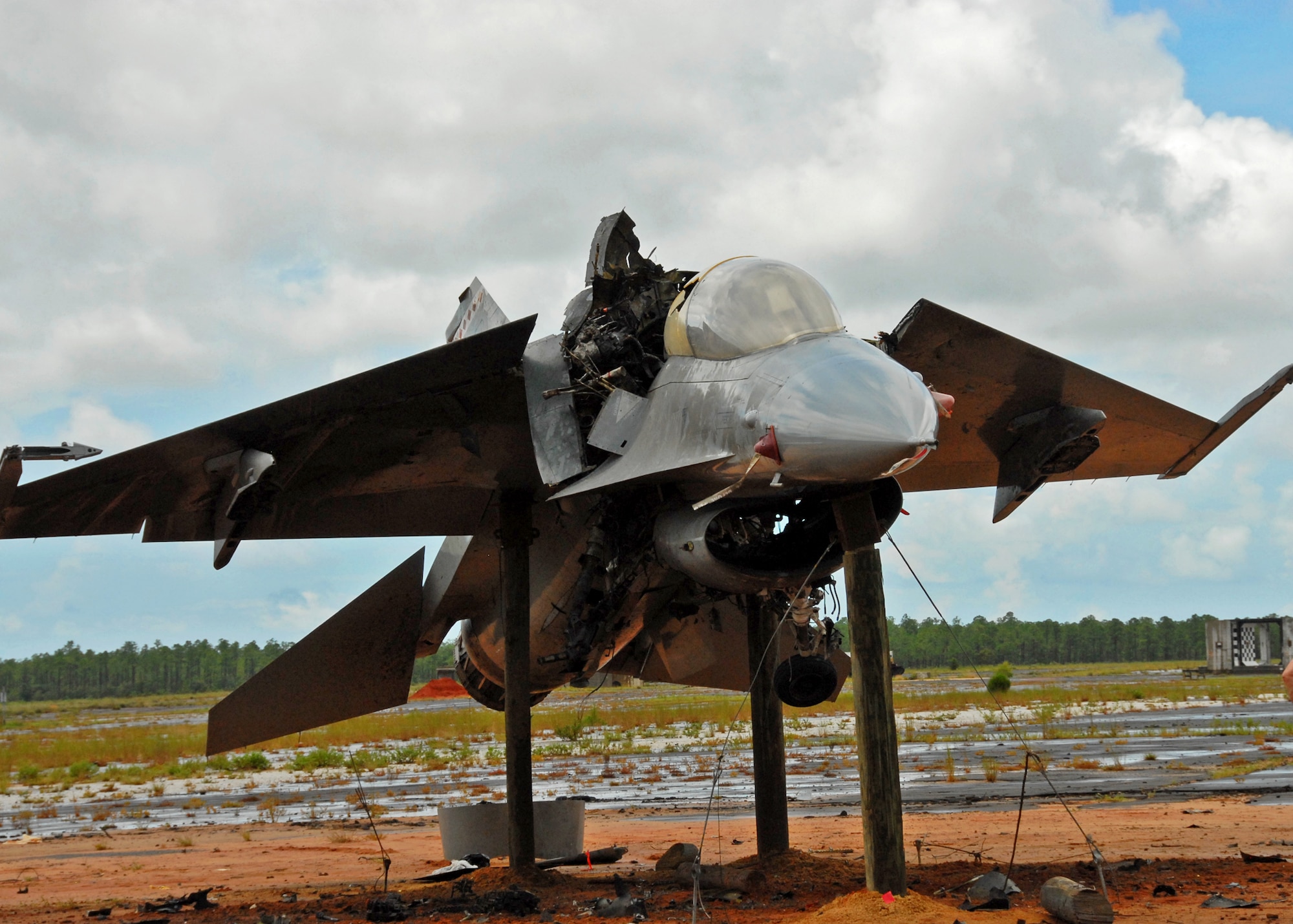 An explosion ripped an F-16 Fighting Falcon into two pieces and scattered debris across the Eglin range Aug. 19.  The explosion was a test of the flight termination system to be used in the QF-16.  The purpose was to demonstrate that the FTS design will be sufficient to immediately terminate the flight of a QF-16, as well as determine a range safety debris footprint.  (U.S. Air Force photo/Samuel King Jr.)