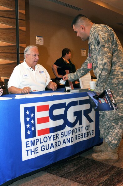 Army Spc. Roberto Mungaray talks about veterans’ employment rights with Darren Venters from the Arizona Office of Employer Support of the Guard and Reserve, Aug. 21, at Tucson’s first Yellow Ribbon Reintegration event. (Air Force photo by Maj. Gabe Johnson)