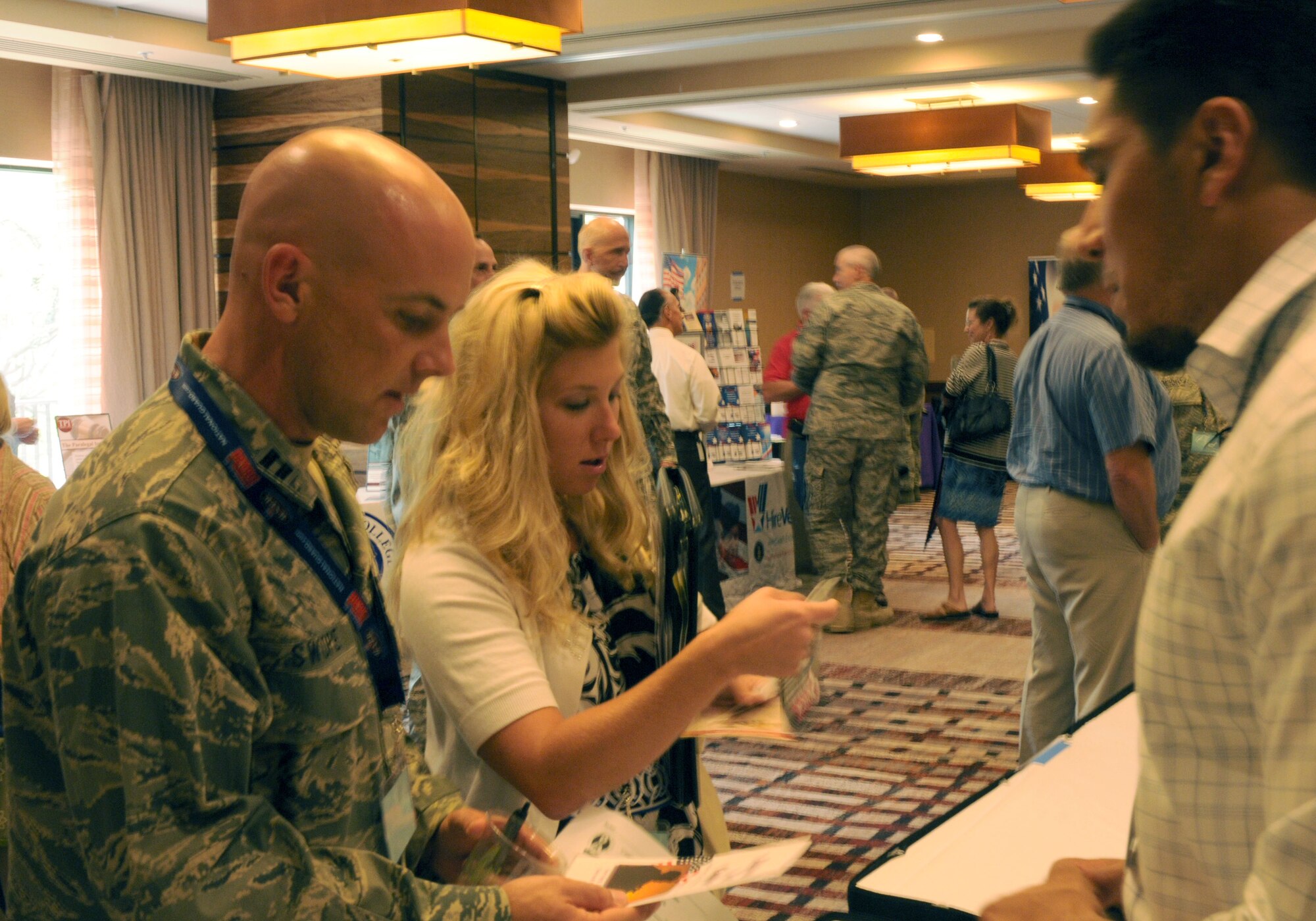 Capt. Ben Swope and his wife Addie visit with community partners during Tucson’s first Yellow Ribbon Reintegration event at the Westin La Paloma resort, Aug. 21. Captain Swope, and 30 members of Tucson’s 162nd Security Forces Squadron, participated in the event designed to help servicemembers transition back to life at home. The squadron redeployed from Iraq June 7 after a five month tour. (Air Force photo by Maj. Gabe Johnson)